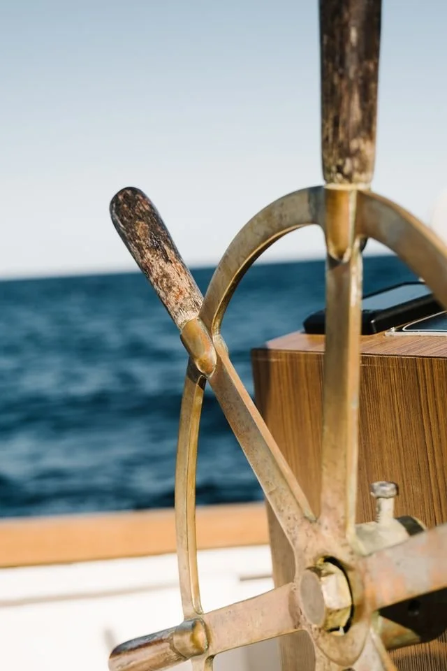 A boat steering wheel on the ocean