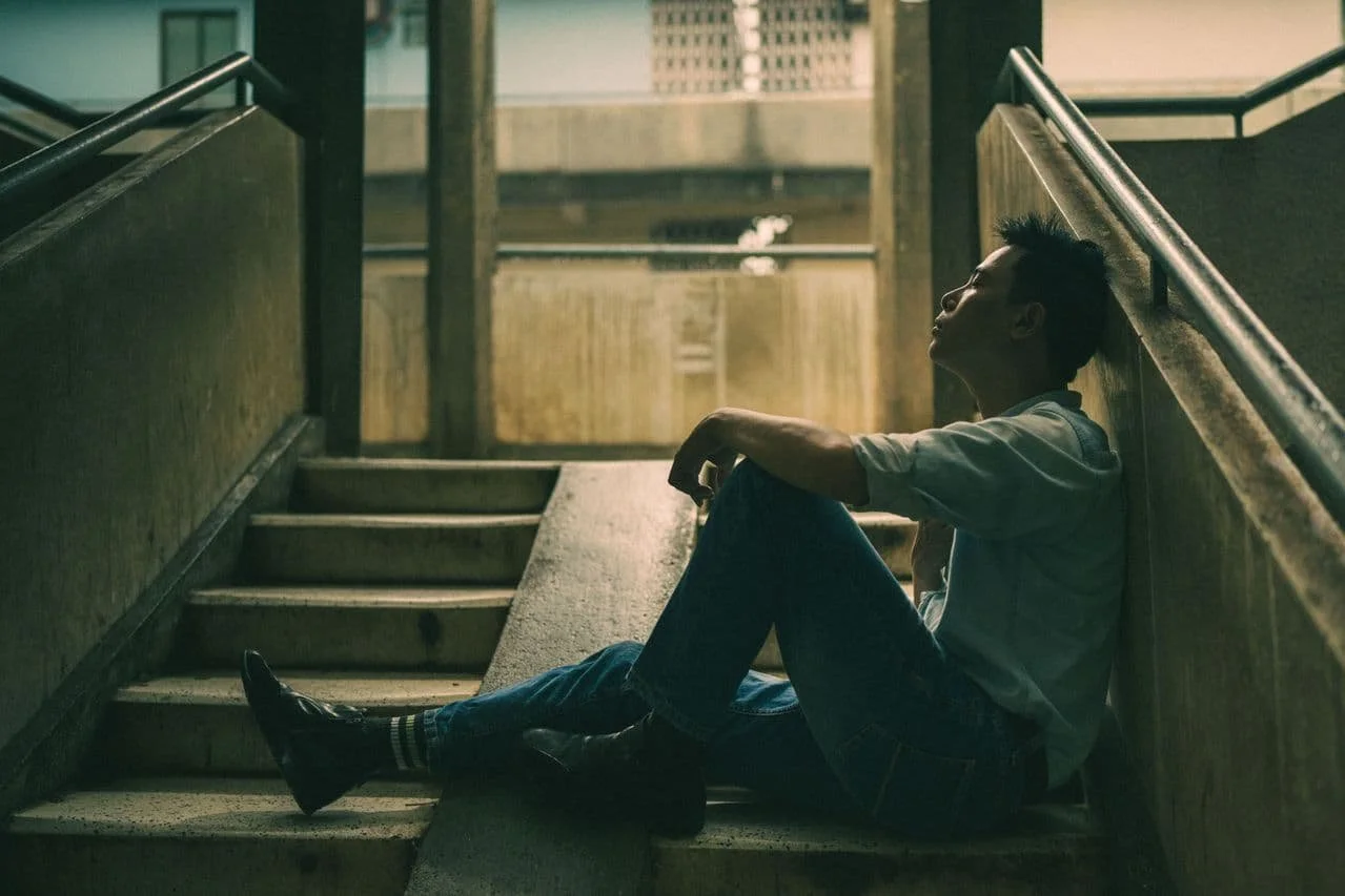 man-sitting-on-the-stairs-in-a-building