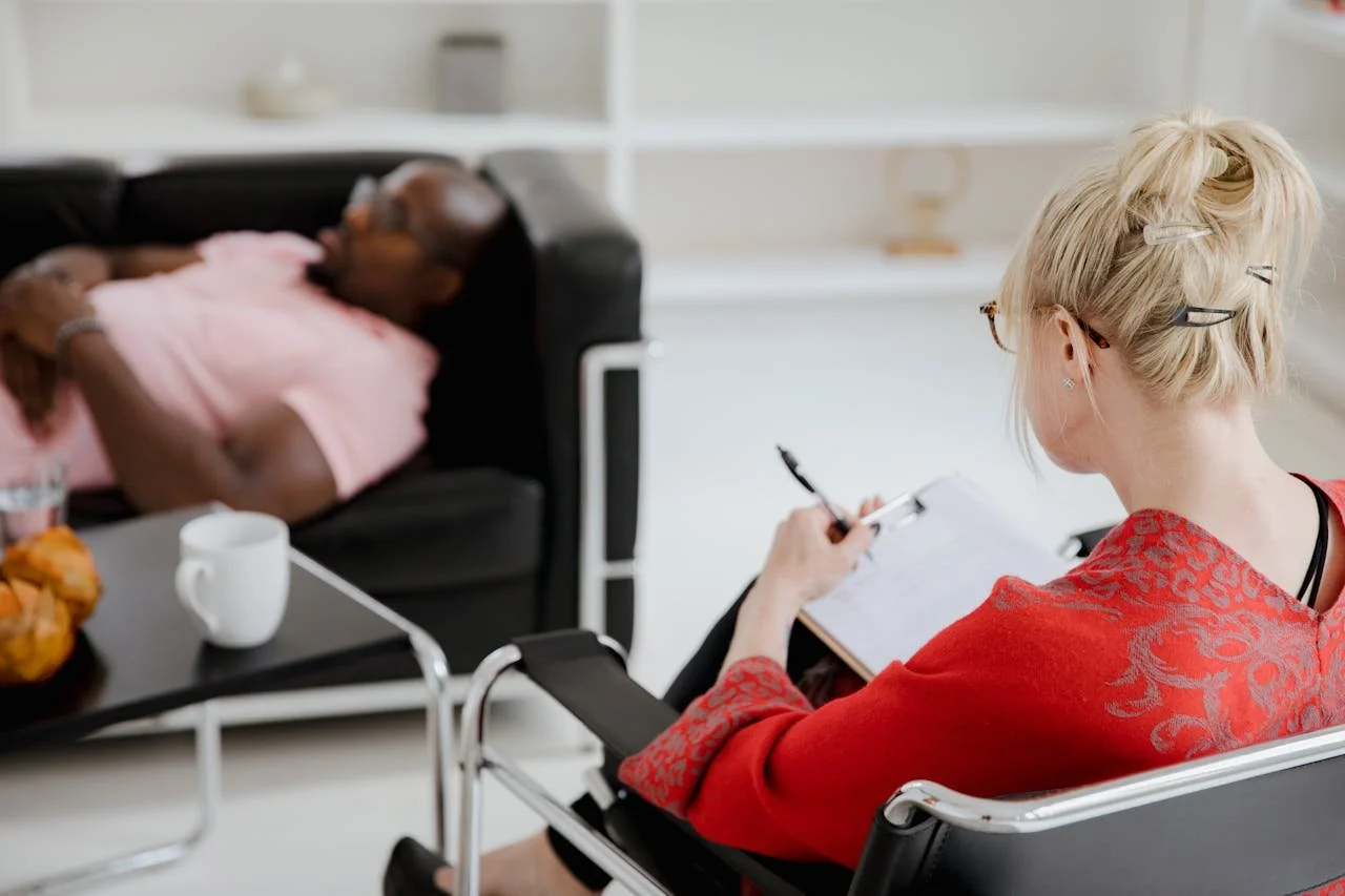 woman-in-red-sweater-sitting-on-black-chair