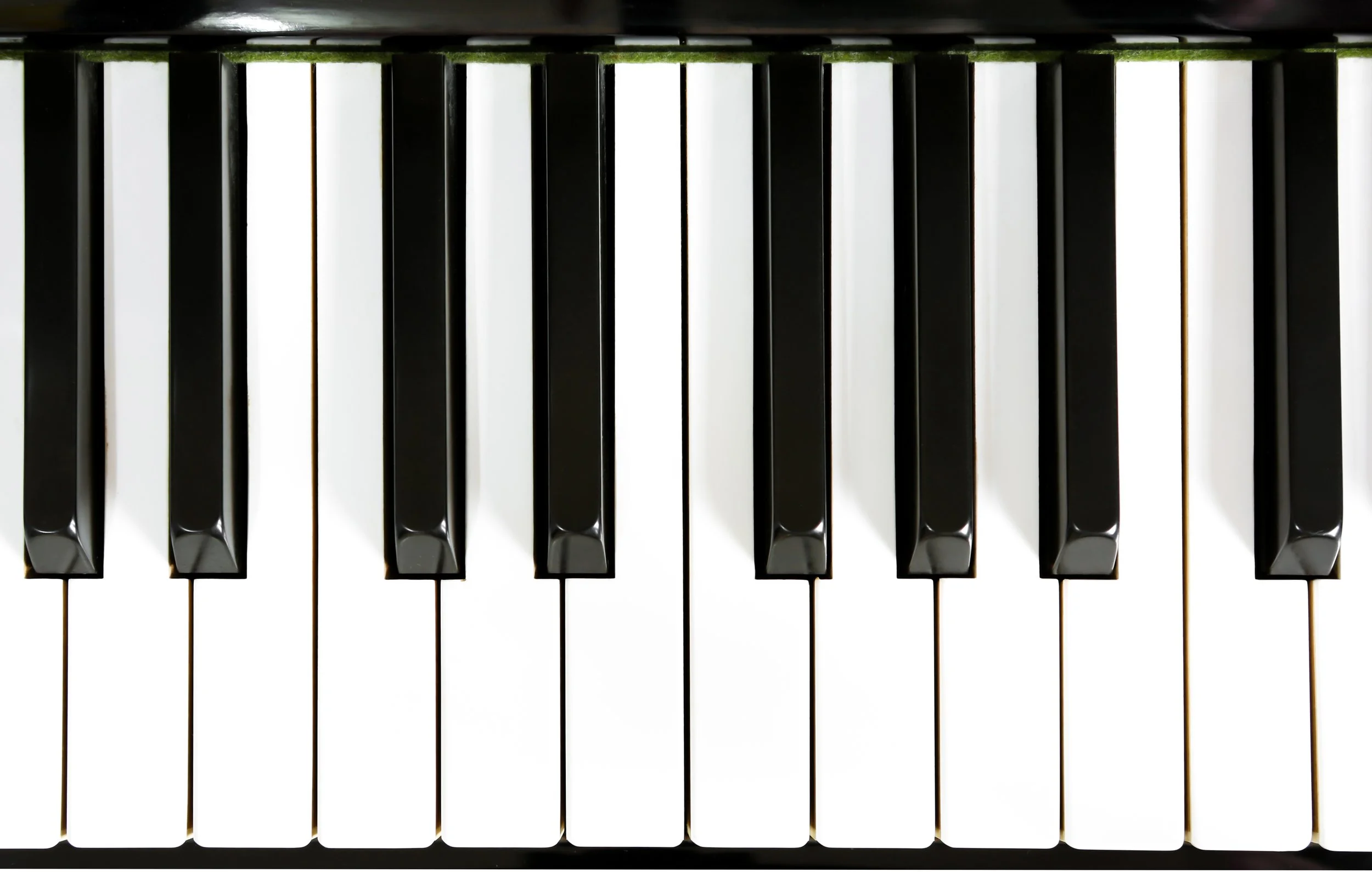 Close-up view of piano keys, showing white and black keys from above.