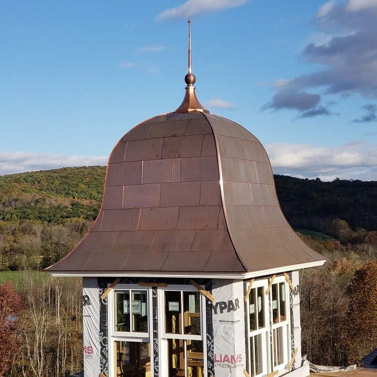Custom copper dome and finial by Slate and Copper Services in Portsmouth, Rhode Island and Easton, Connecticut, serving Fairfield County, Providence, coastal RI, and South Coast, MA.