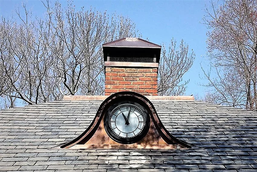 A clock and copper chimney cap by Slate & Copper Services, Portsmouth, RI, and Easton, CT
