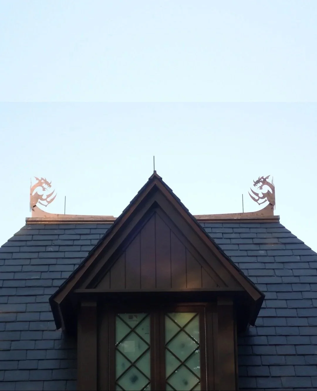 Slate roof and custom copper dragon finials by Slate and Copper Services in Portsmouth, Rhode Island and Easton, Connecticut, serving Fairfield County, Providence, coastal RI, and South Coast, MA.