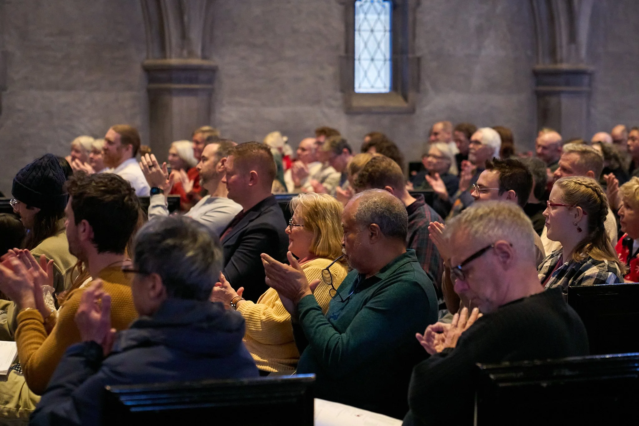 A large audience applauds at a Sphere Born concert at Trinity Episcopal Church, Indianapolis