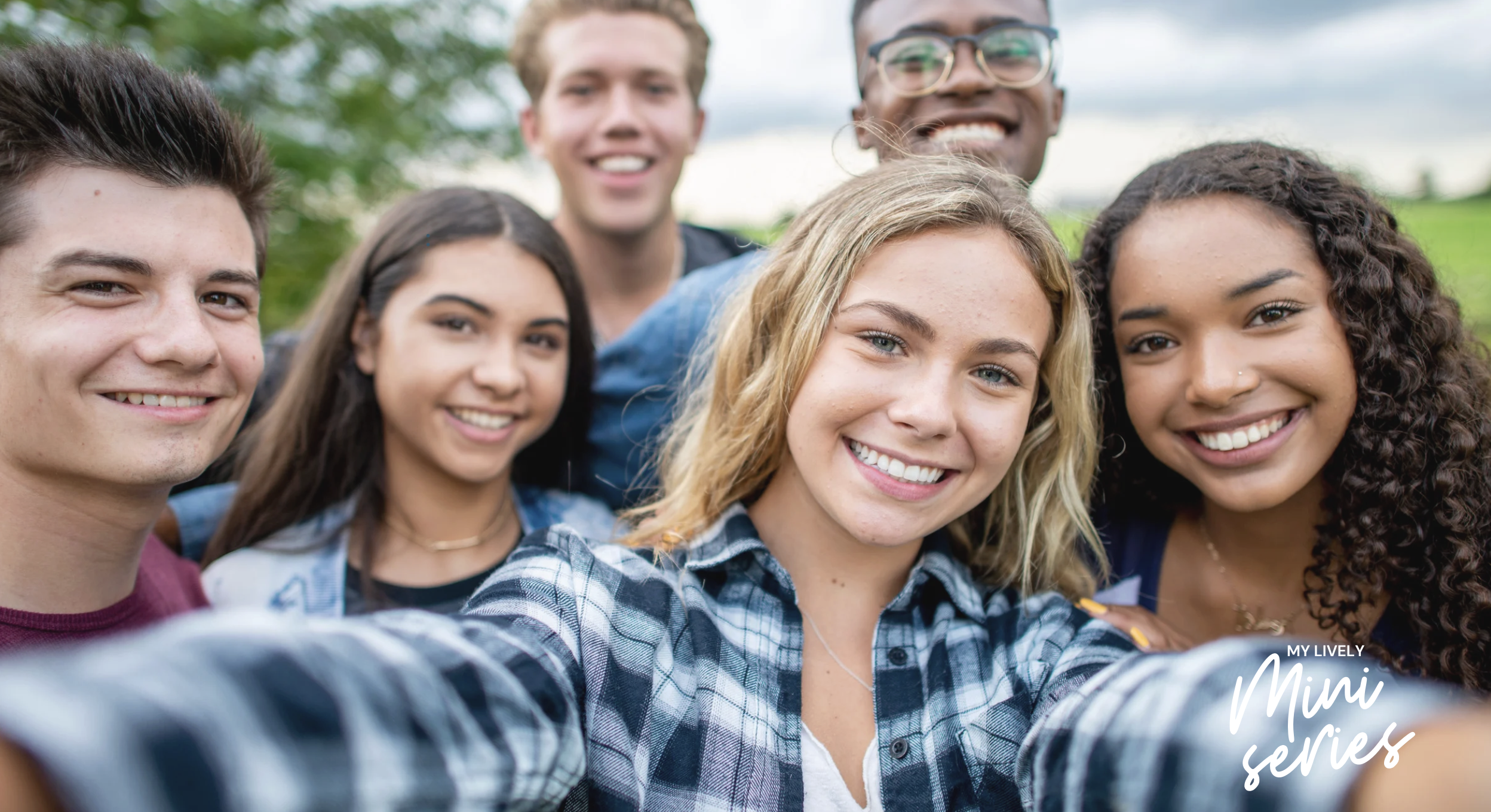 A group of students with varying skin tones and hair colors smiling