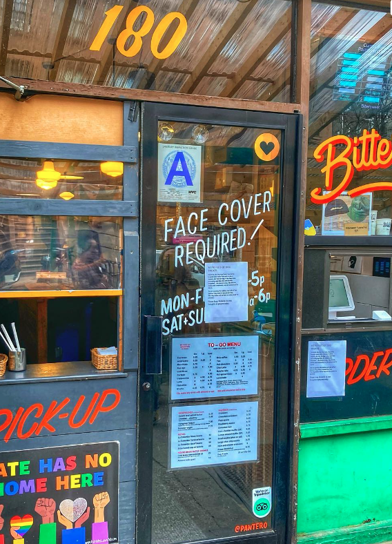 "Face cover required" window signage
