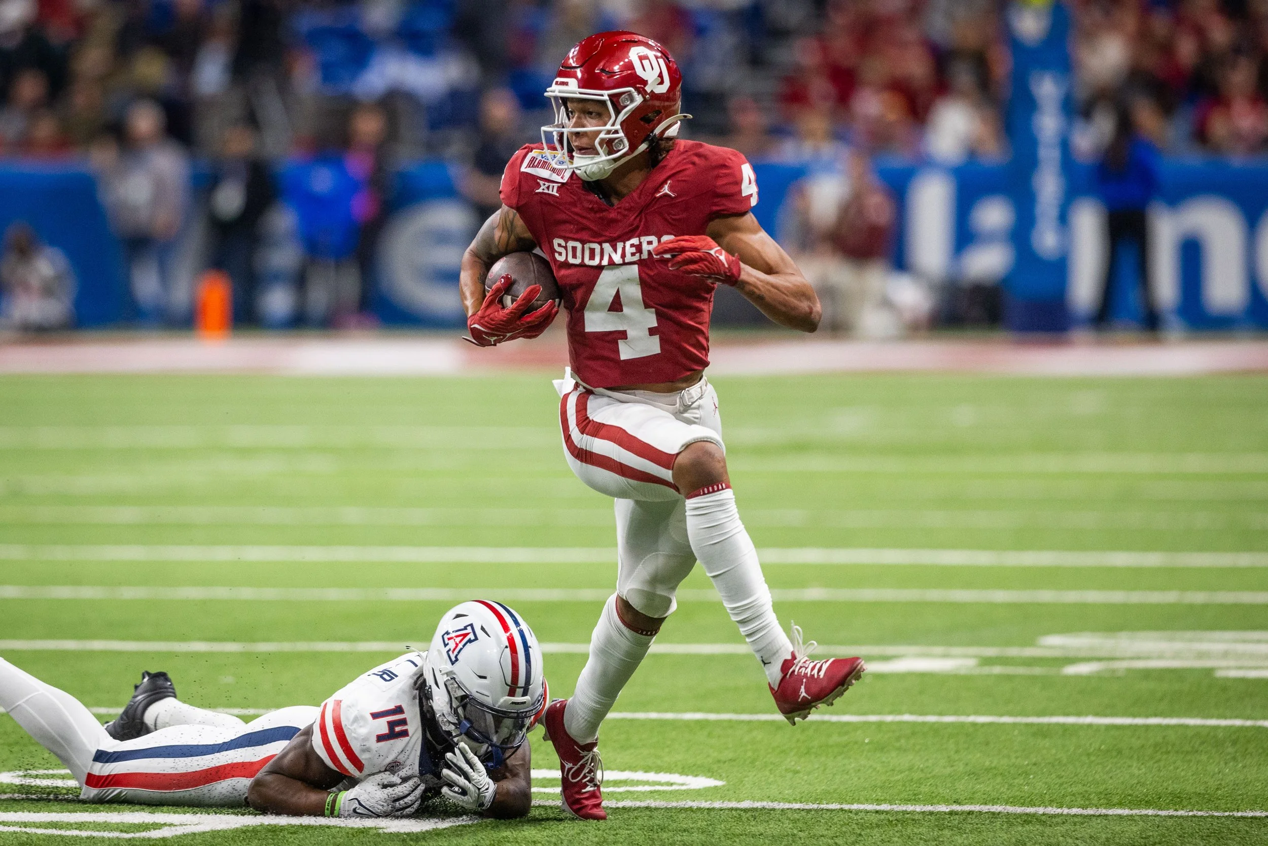 American football player wearing a red jersey with the number 4 and 