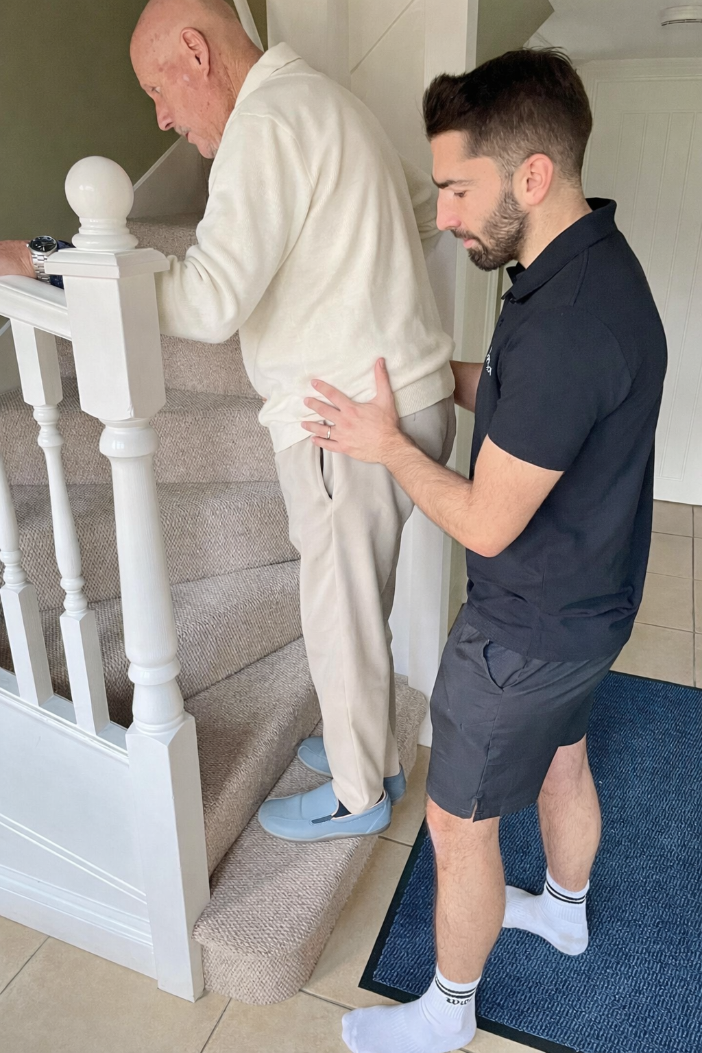 Physio helping patient upstairs