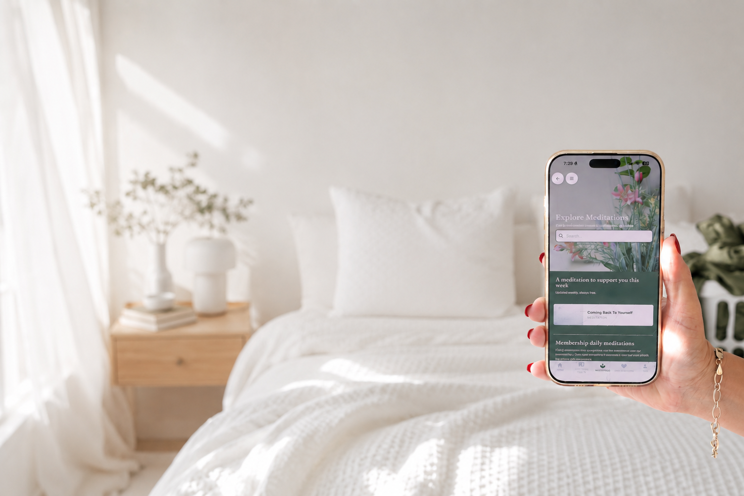 Samantha Elle holding an iPhone displaying the Resiliently meditation app, with a softly blurred bedroom and everyday washing in the background, reflecting the realities of creating moments of calm at home.