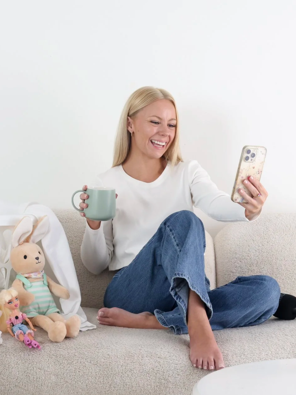 Gold Coast Influencer Samantha Elle, showing her authentic ADHD self recording an instagram reels whilst drinking a coffee. She's known for her authentic story-telling and has a growing audience of women around the world on instagram.