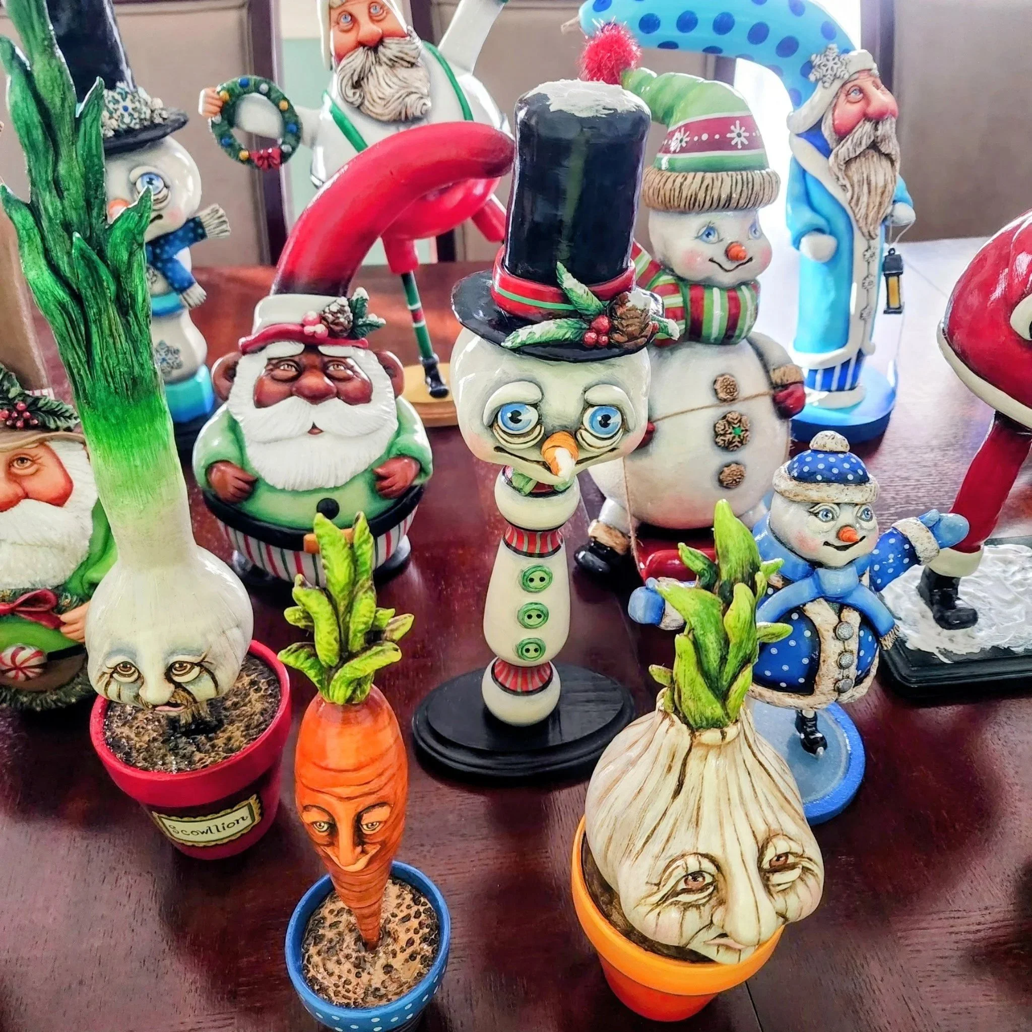 Decorative, seasonal sculptures made out of gourds and air dry clay.  Sculptures include gnomes, Santas, and whimsical vegetables in hand painted ceramic pots.
