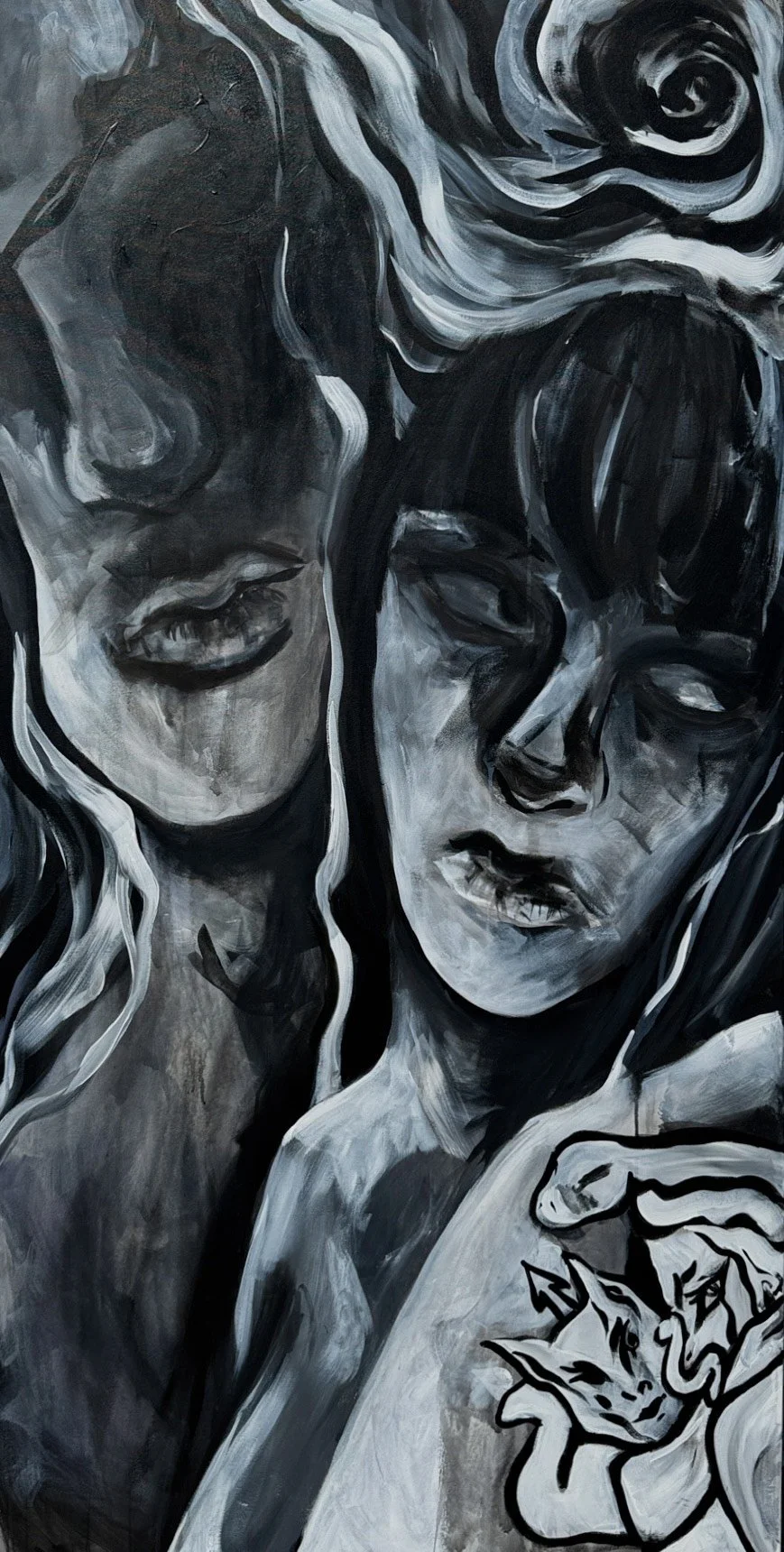 A black and white mural of two women with long hair, one with eyes closed and the other with eyes open, with detailed facial features and expressive poses.