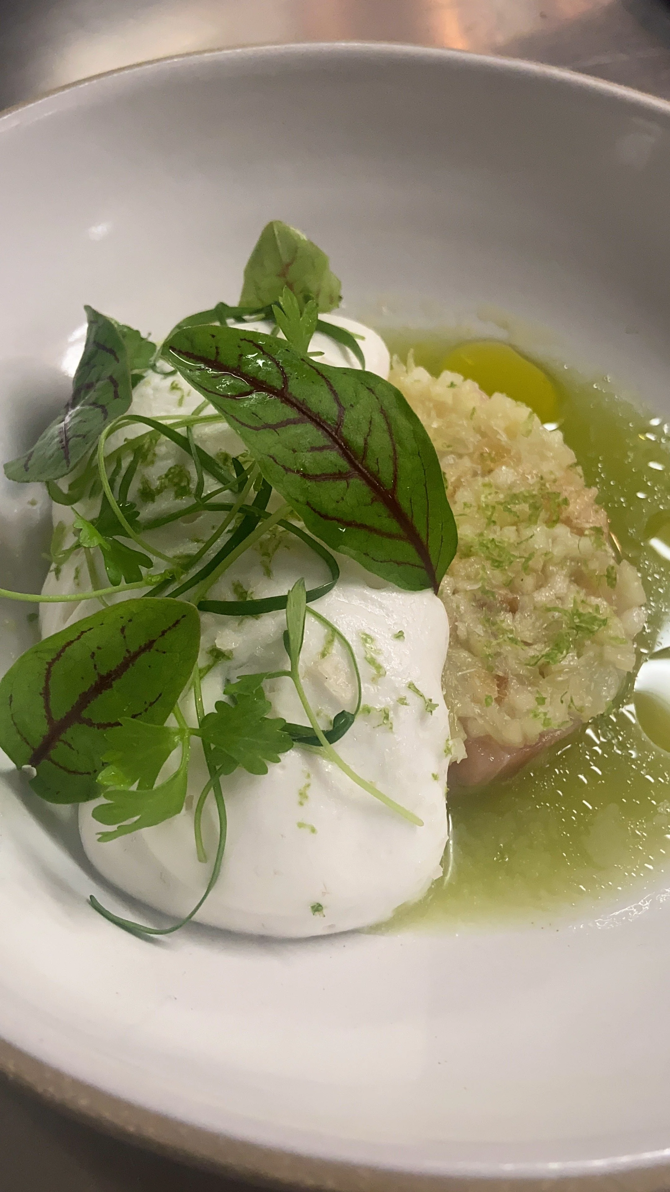 Poached eggs topped with microgreens, served with a side of chutney and lime wedge.