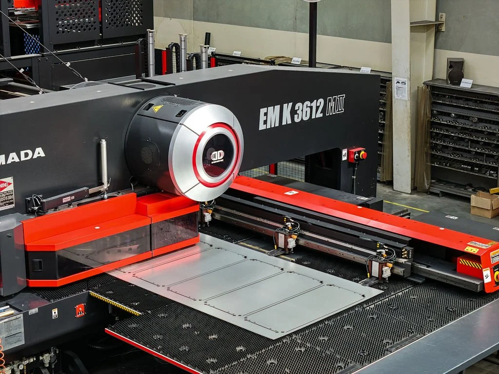 A large industrial laser cutting machine in a workshop.