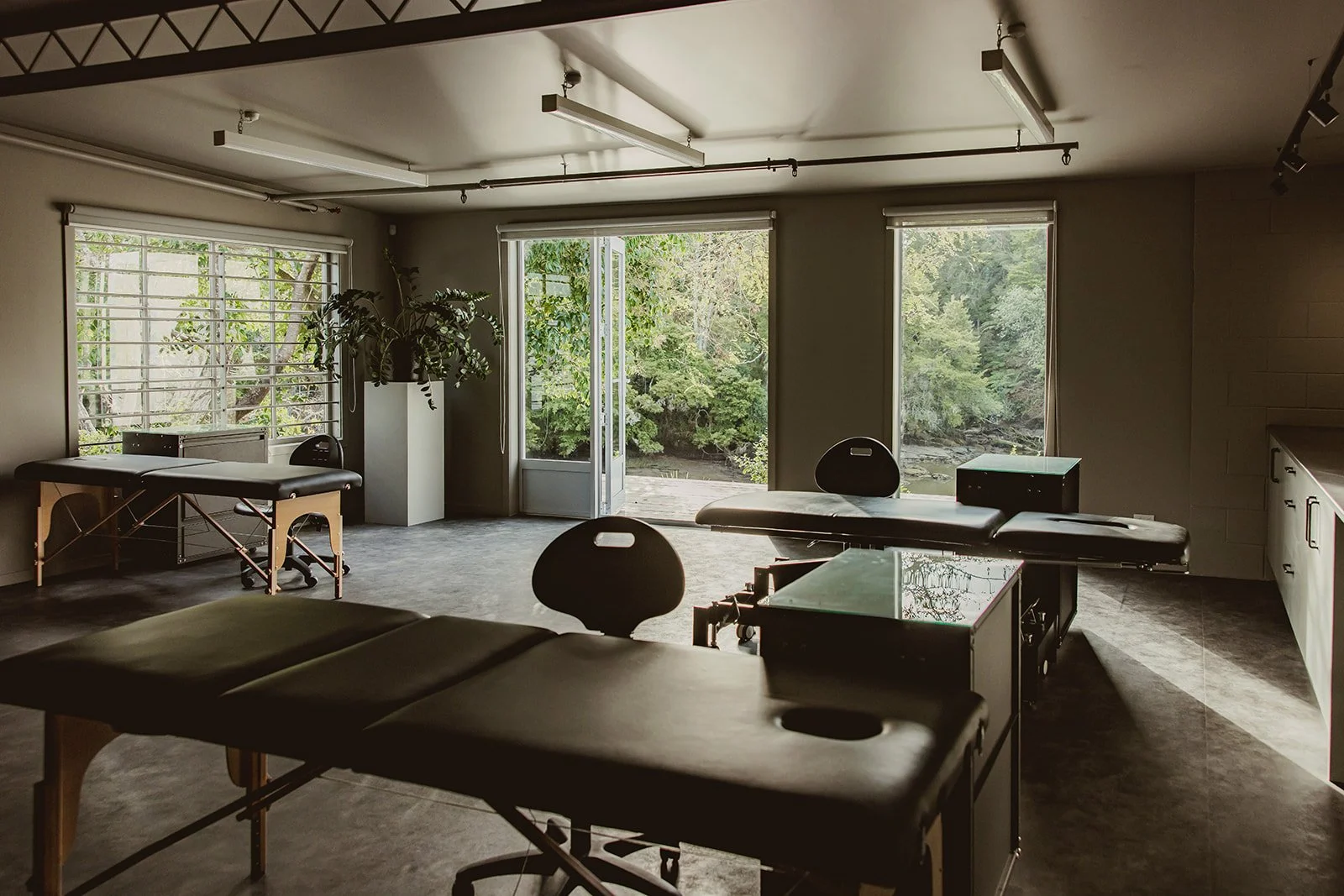 Interior of The Brave tattoo located in Warkworth, large windows, and greenery outside.