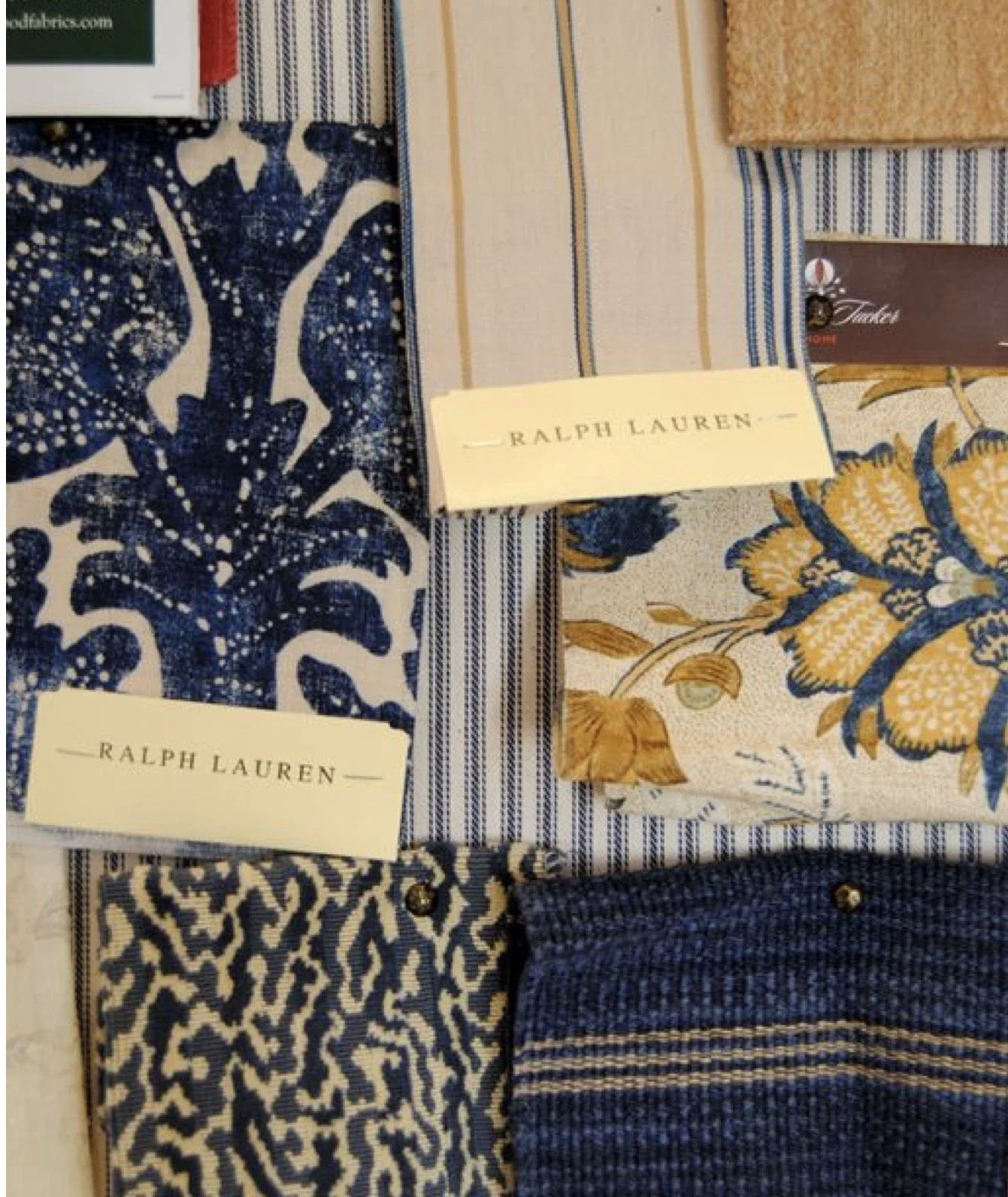 Close-up view of fabric samples with various patterns and colors on display, with Ralph Lauren labels visible.