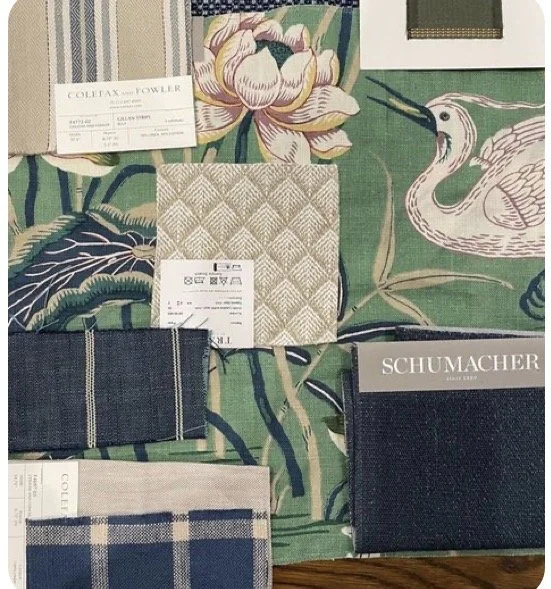 Fabric swatches and samples, some with floral and checkered patterns, placed on a tropical-themed green fabric background with a swan illustration.