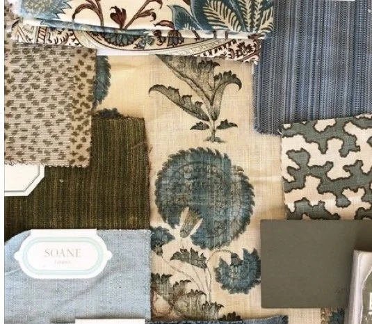 A display of various patterned fabric swatches arranged on a flat surface, including floral, geometric, and textured designs.