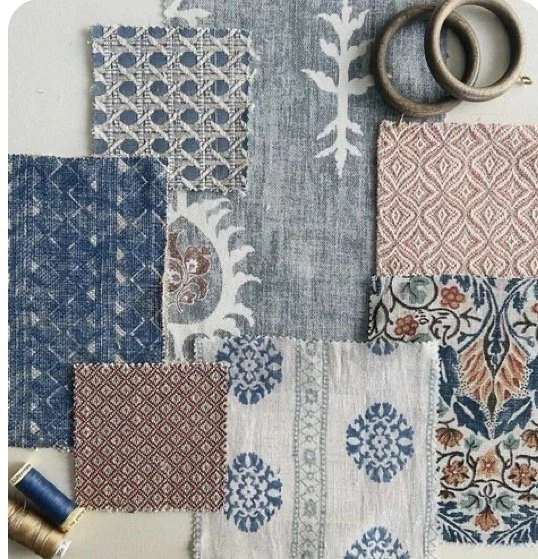 A collection of fabric samples with various patterns and colors, along with two metal rings.