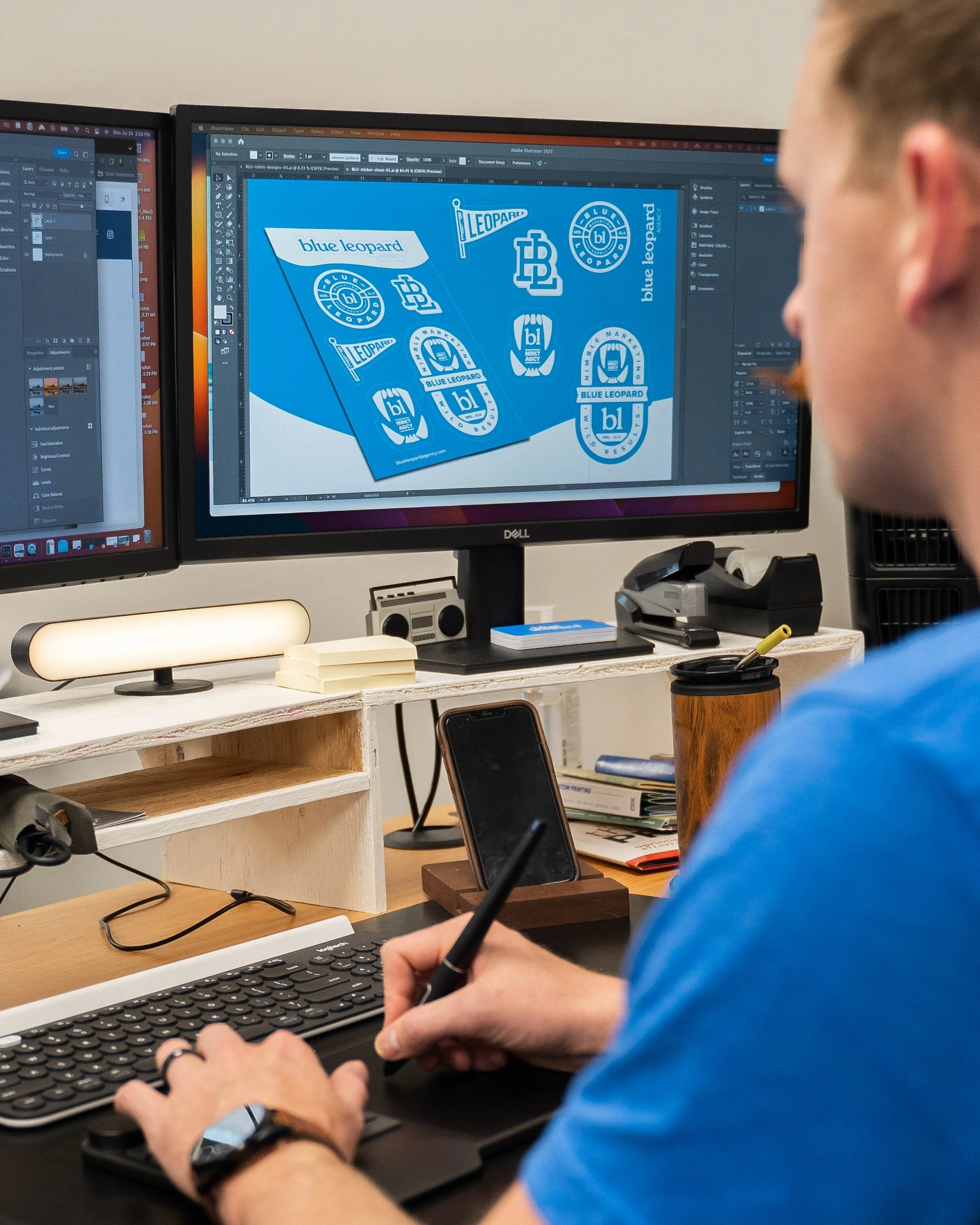 Designing logos on a computer screen, featuring blue leopard themed logos and badges with text like 'blue leopard' and 'BL'.