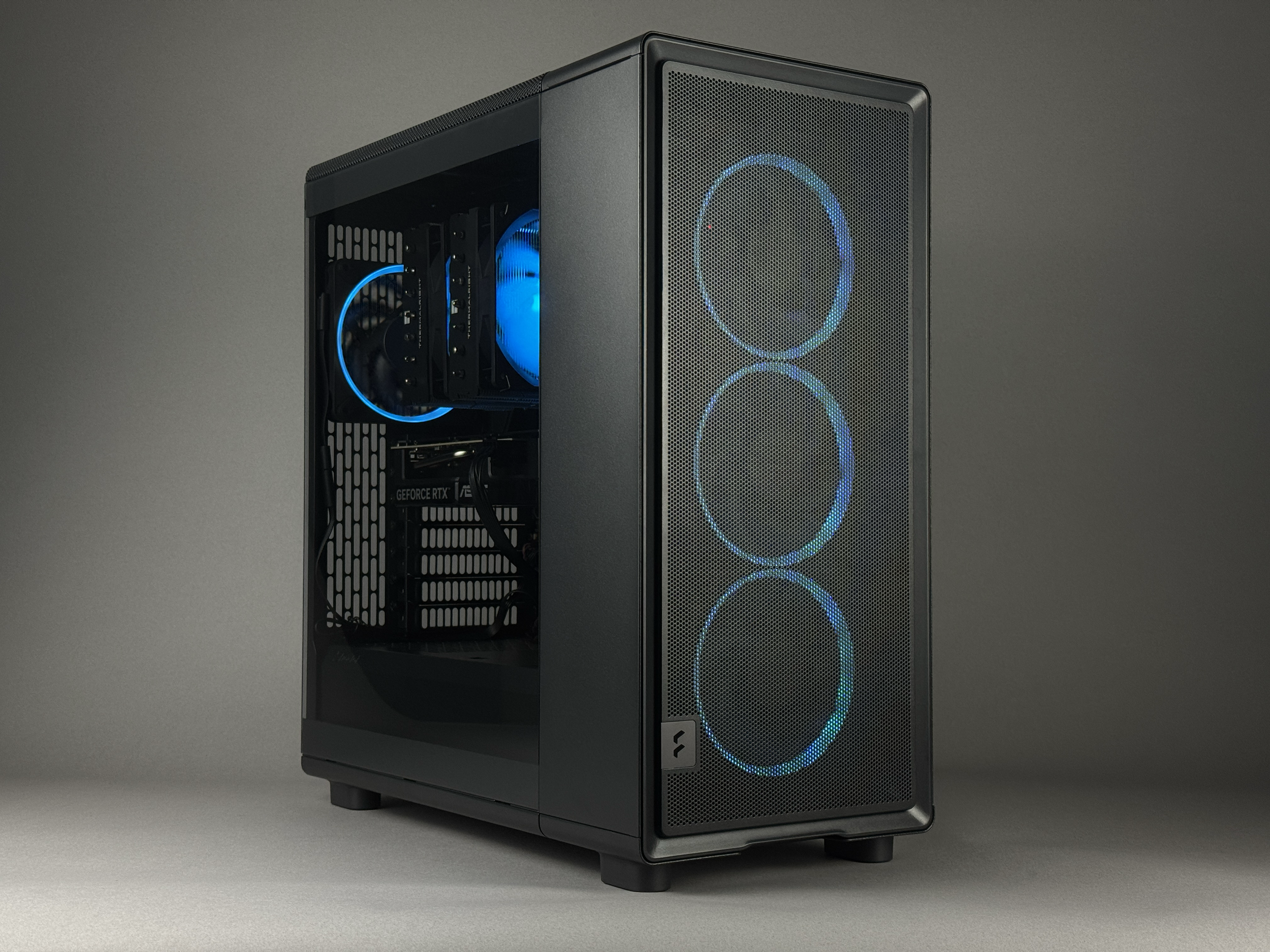 Zenith Z2 gaming PC in a Fractal Epoch case with ARGB Fans and a tempered glass side panel showing internal components. Internal view shows GeForce RTX 5060ti, Thermalright Phantom Spirit CPU cooler with RGB.