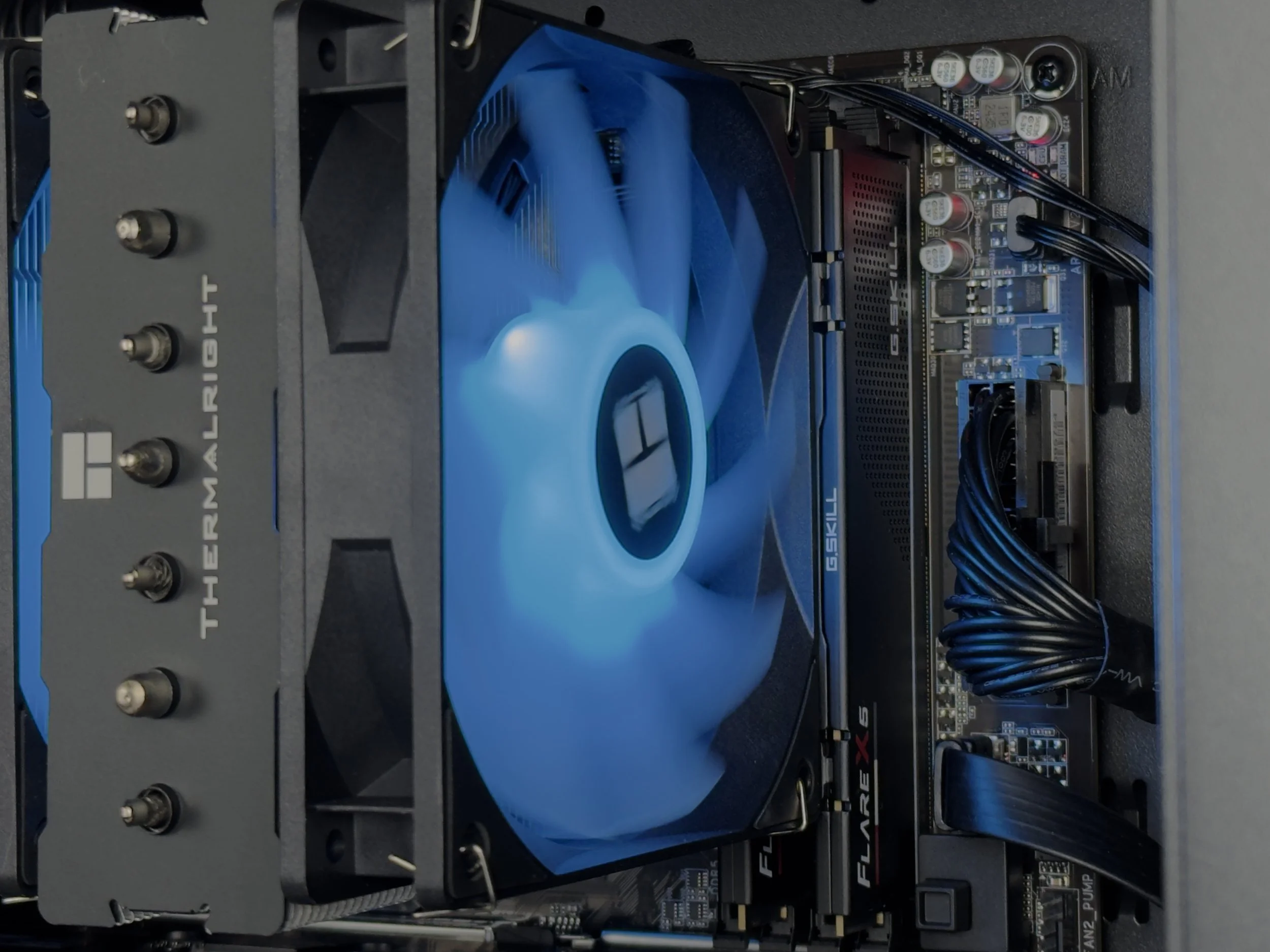 Close-up of the Zenith Z3's motherboard with a  Thermalright CPU Cooler, G. Skill RAM modules, and power cables attached.