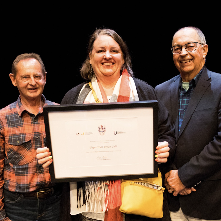 Angela poses with award certificate
