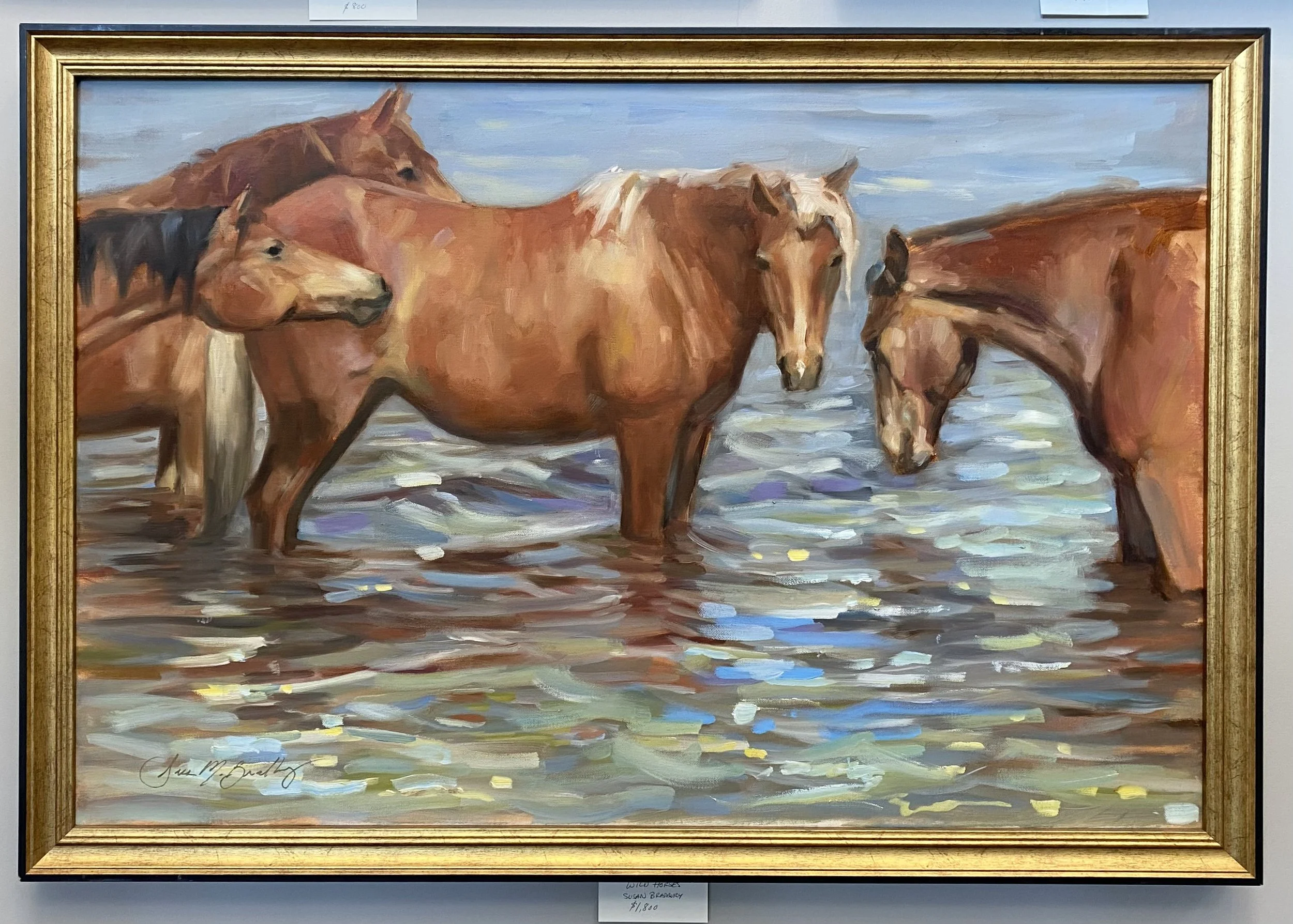 Painting of five horses standing in water, with a blue sky in the background.