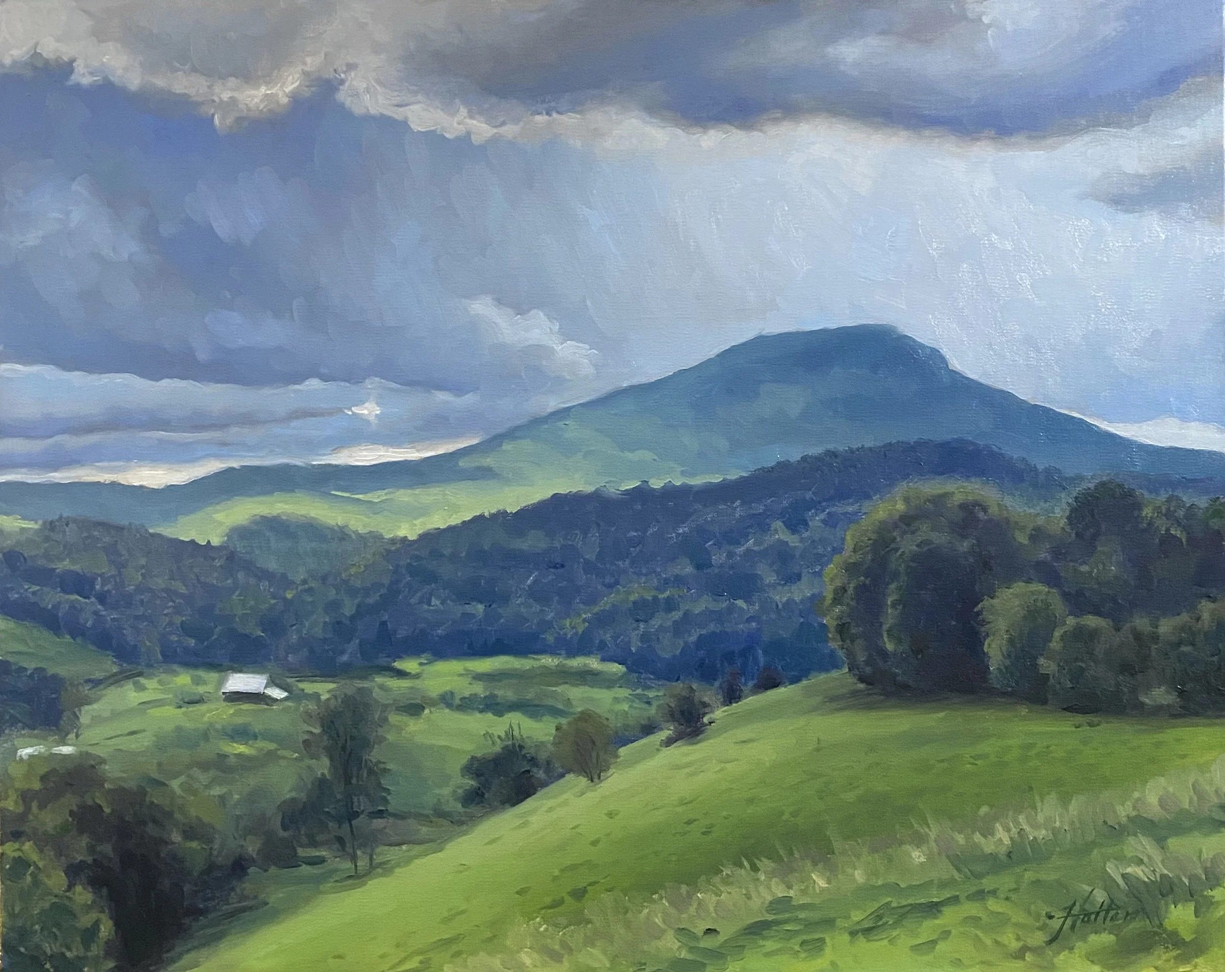 A painting of a landscape with green rolling hills, trees, a mountain in the distance, and a cloudy sky.