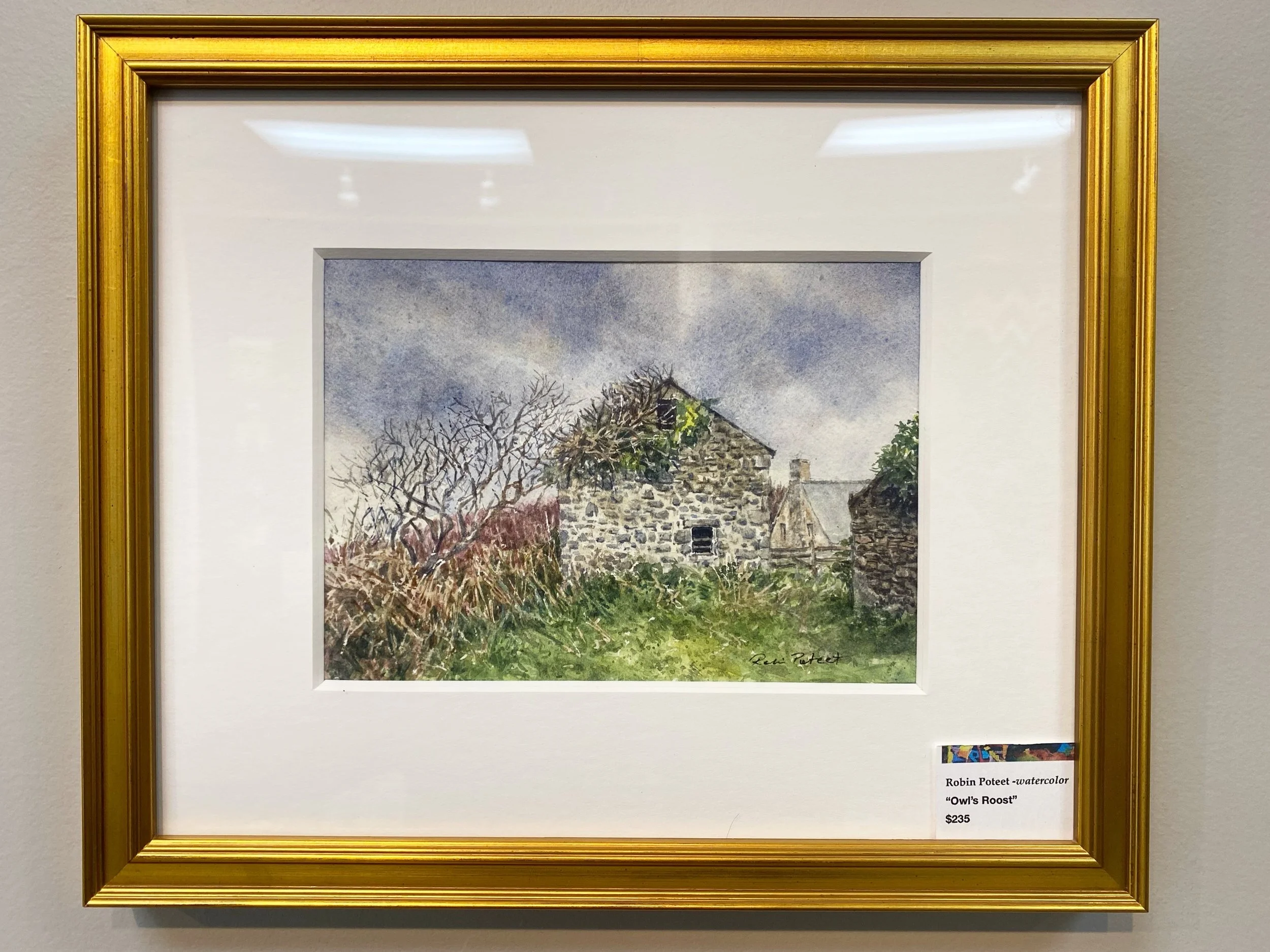 A watercolor painting of a stone house surrounded by leafless trees and a cloudy sky, titled "Owl's Roost," signed by Robin Poteet, priced at $235.