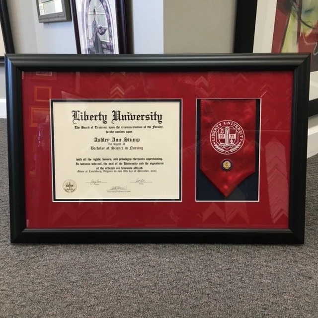 Framed diploma and red ribbon from Liberty University for Ashley Ann Stump, Bachelor of Science in Nursing.