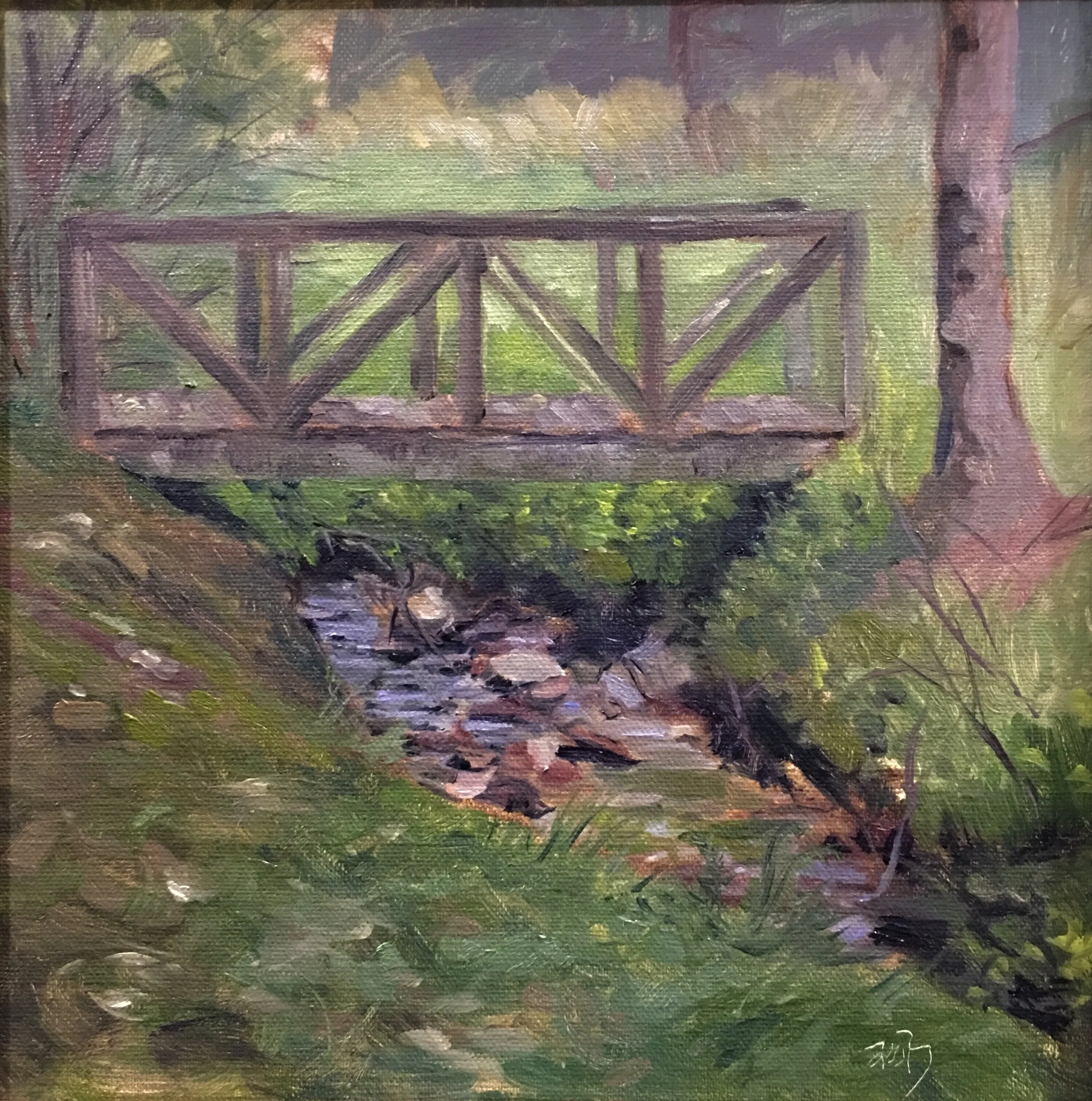 Oil painting of a small wooden bridge crossing over a creek in a lush, green forest.