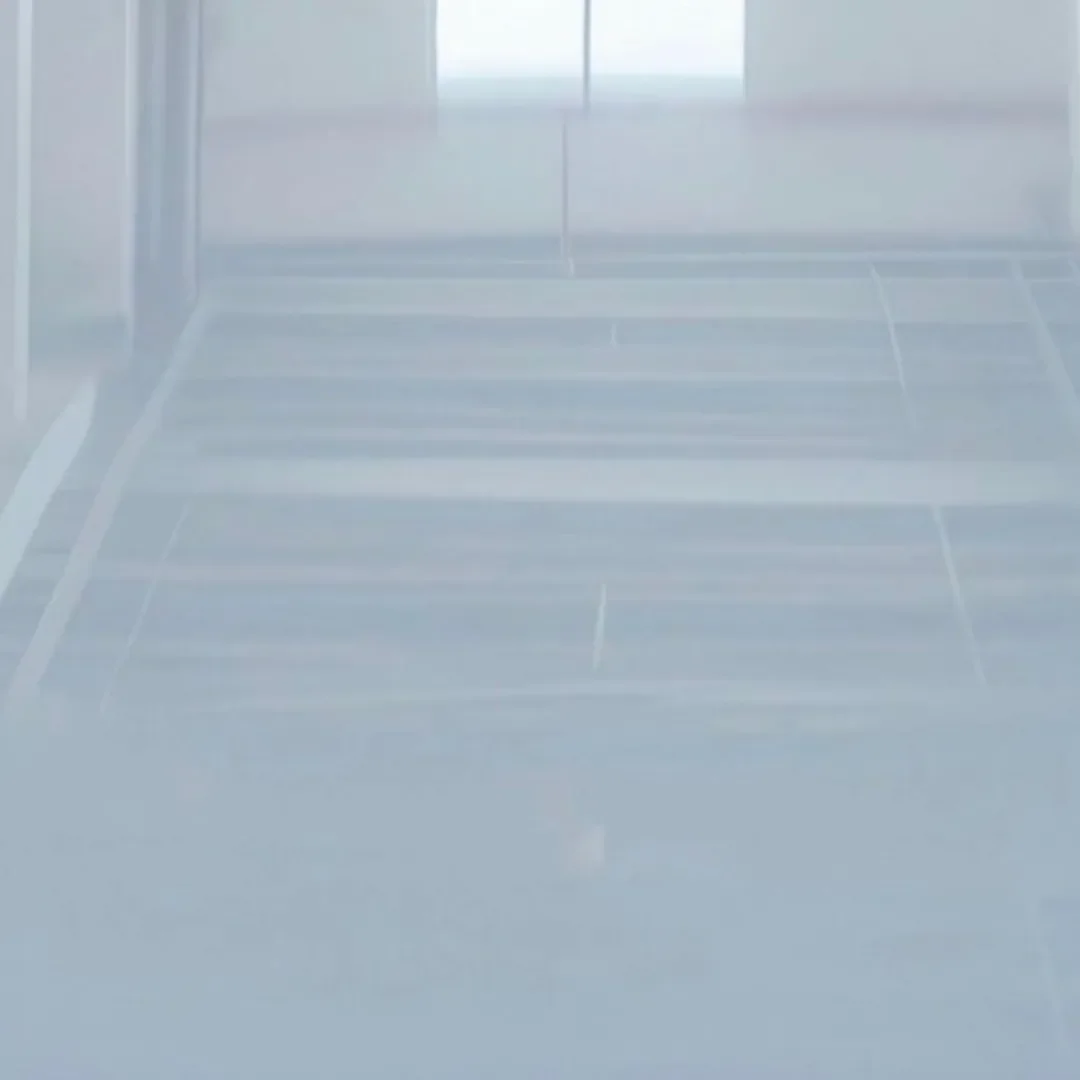 Solid epoxy floor base coat in smooth light gray finish.