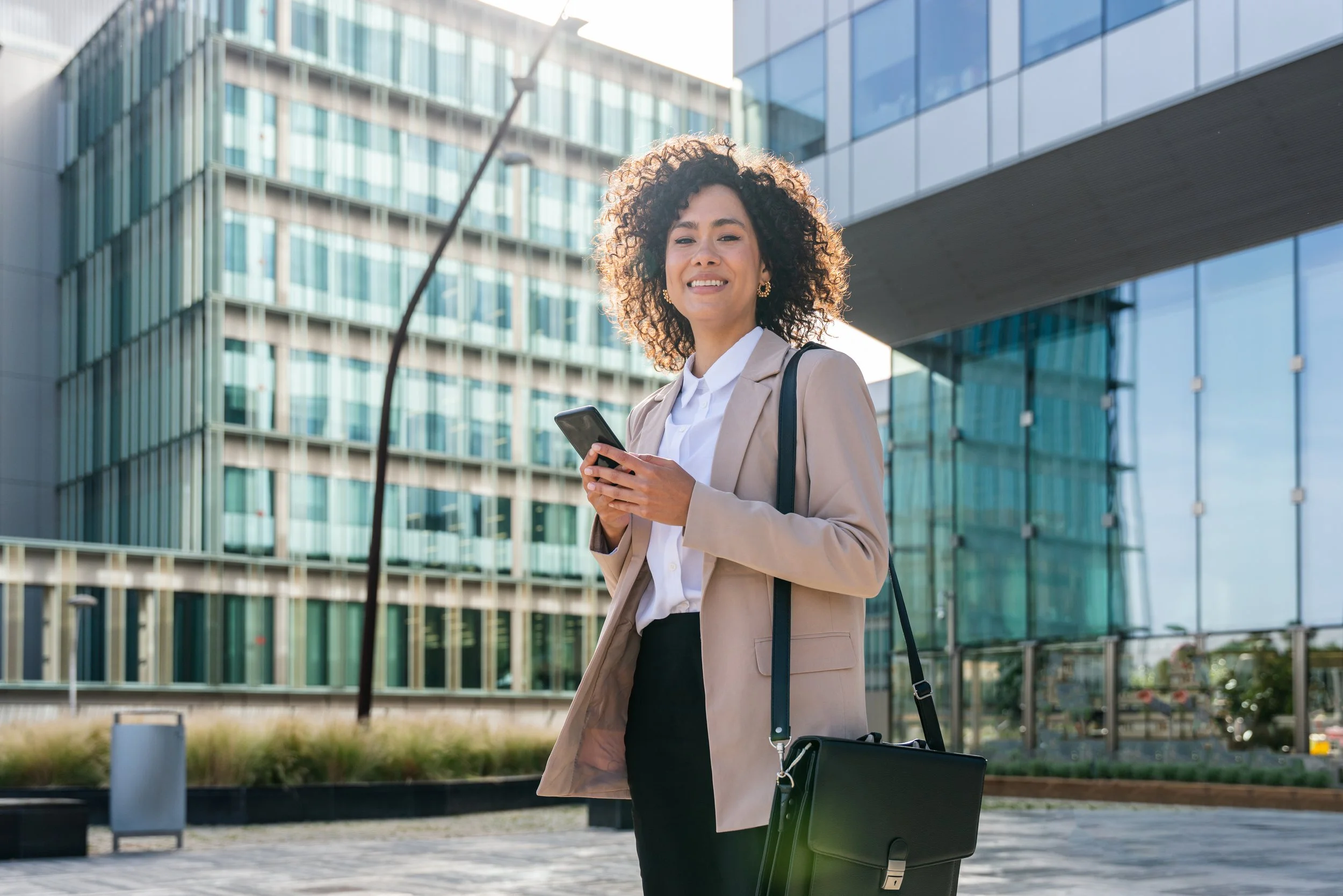Young business woman amongst office buildings