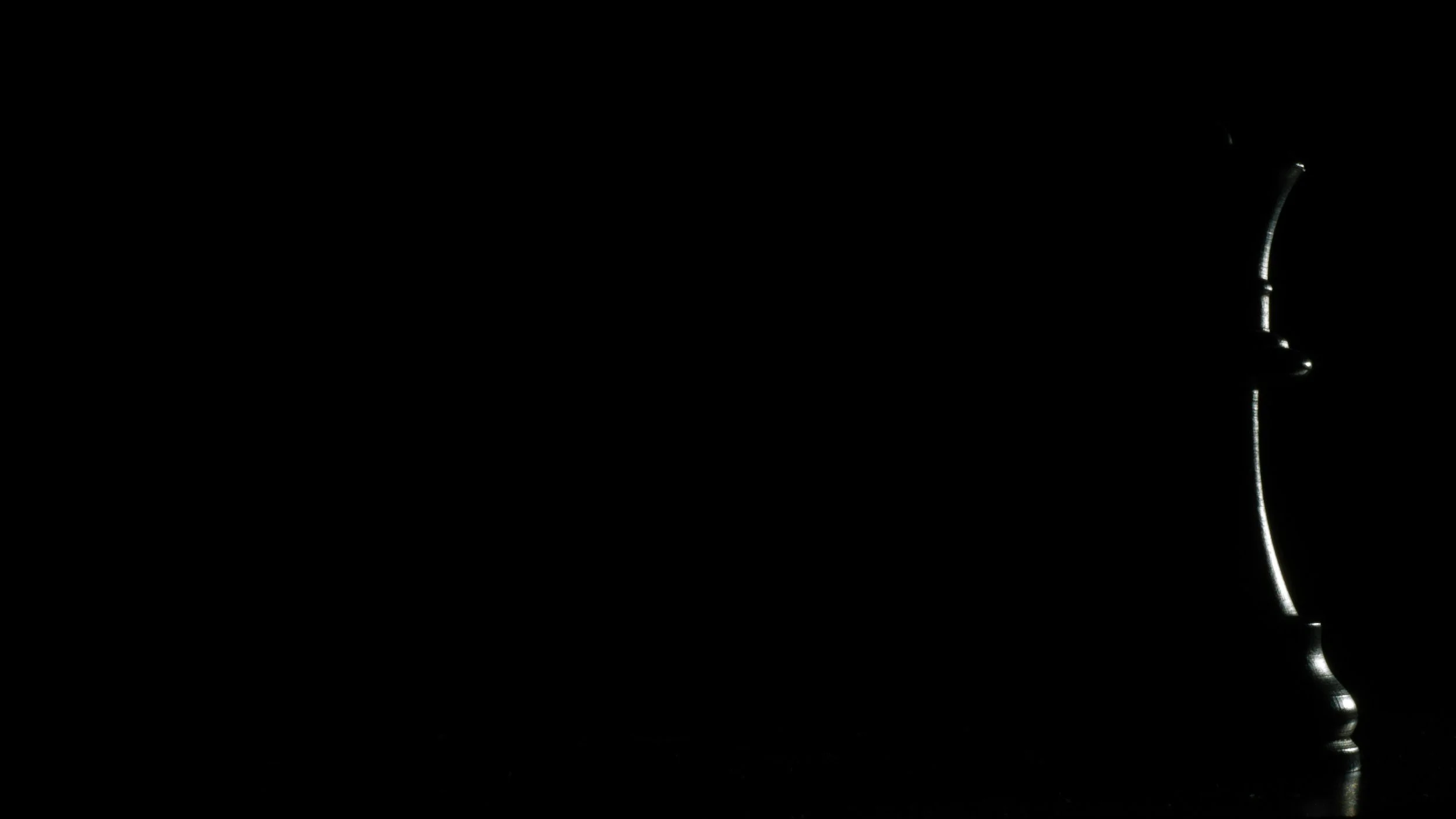 A side profile of a can with metallic edges visible against a black background.