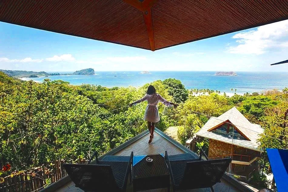 Woman overlooking balcony with sea view