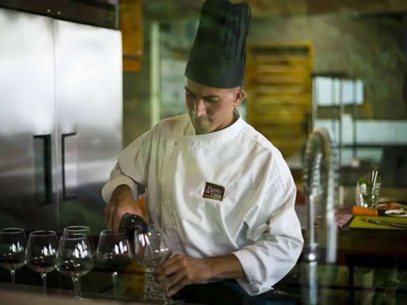 Villa staff pouring wine