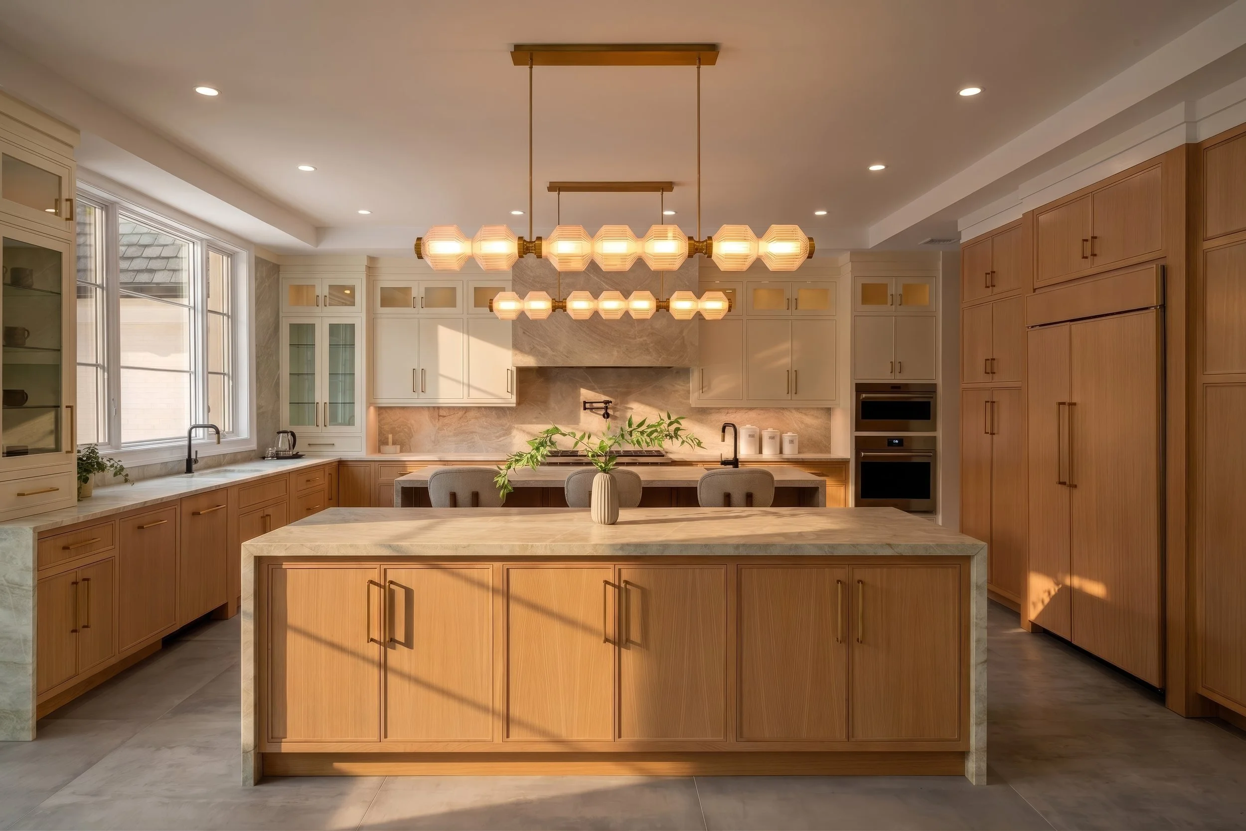 White oak kitchen with large island and globe pendant chandelier