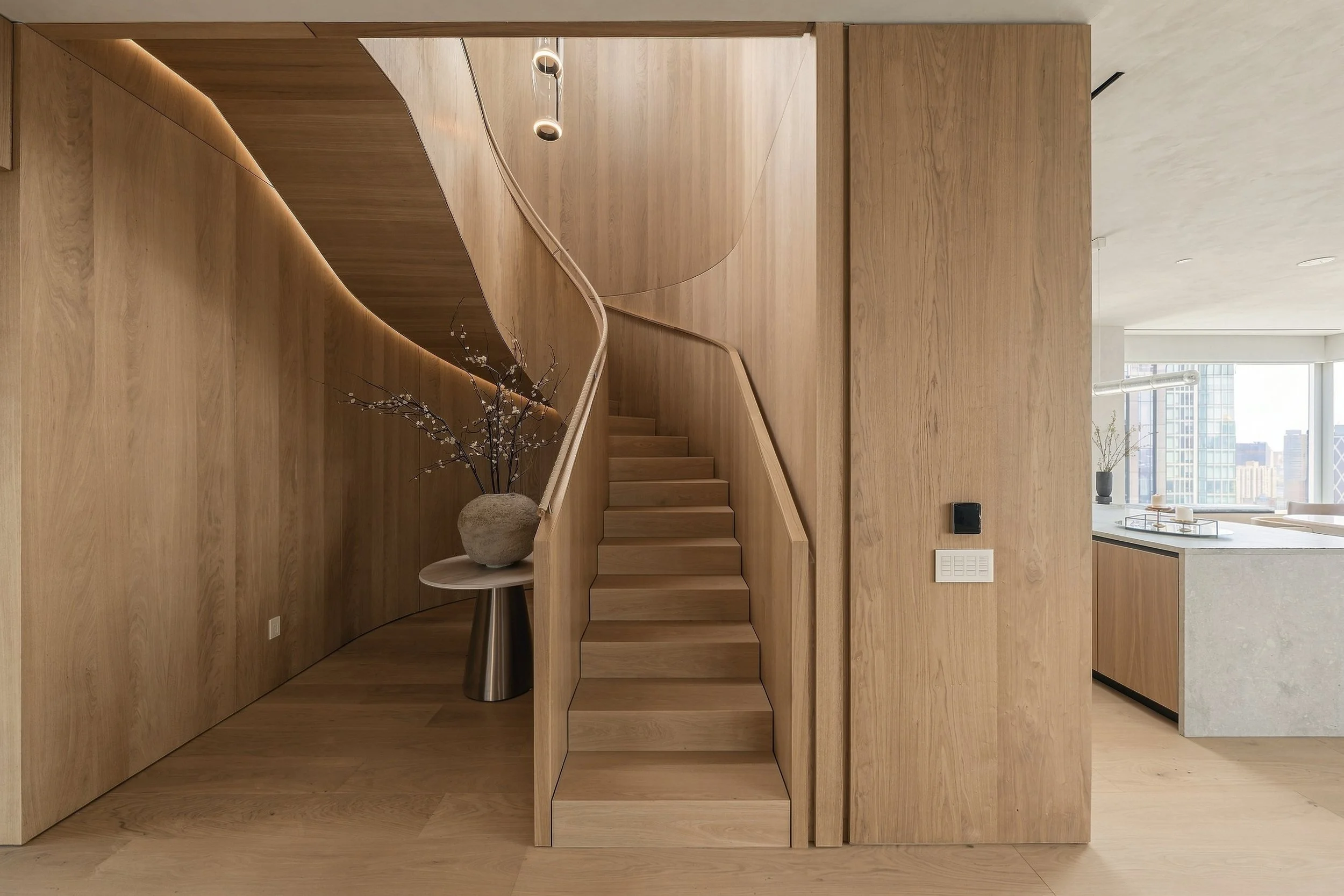 Curved white oak staircase in a Manhattan penthouse