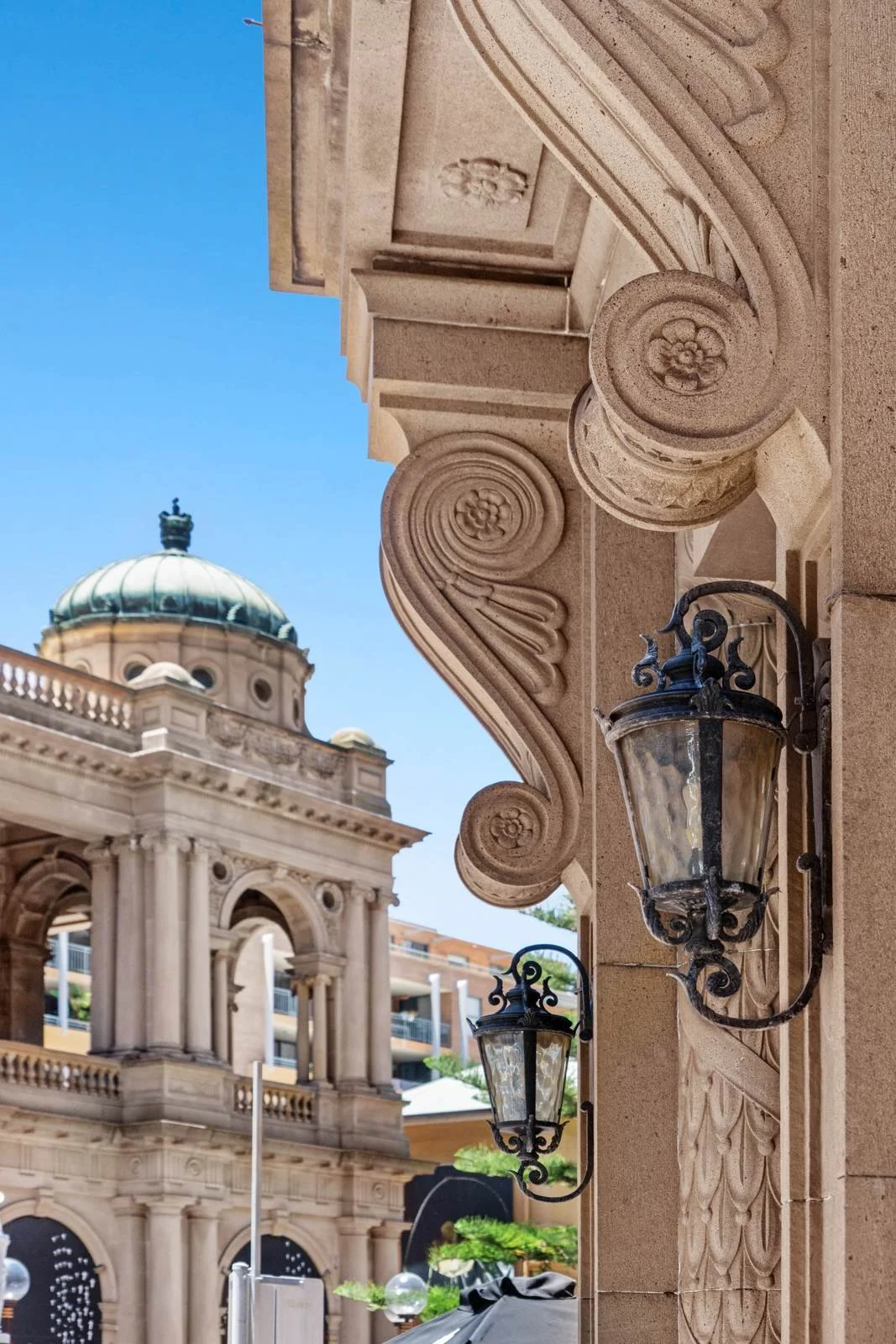 Carved sandstone and a heritage lantern on the facade
