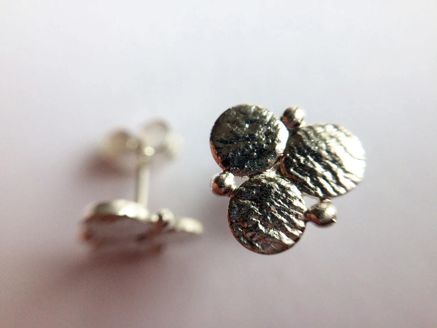 Handmade silver circle earrings on white background