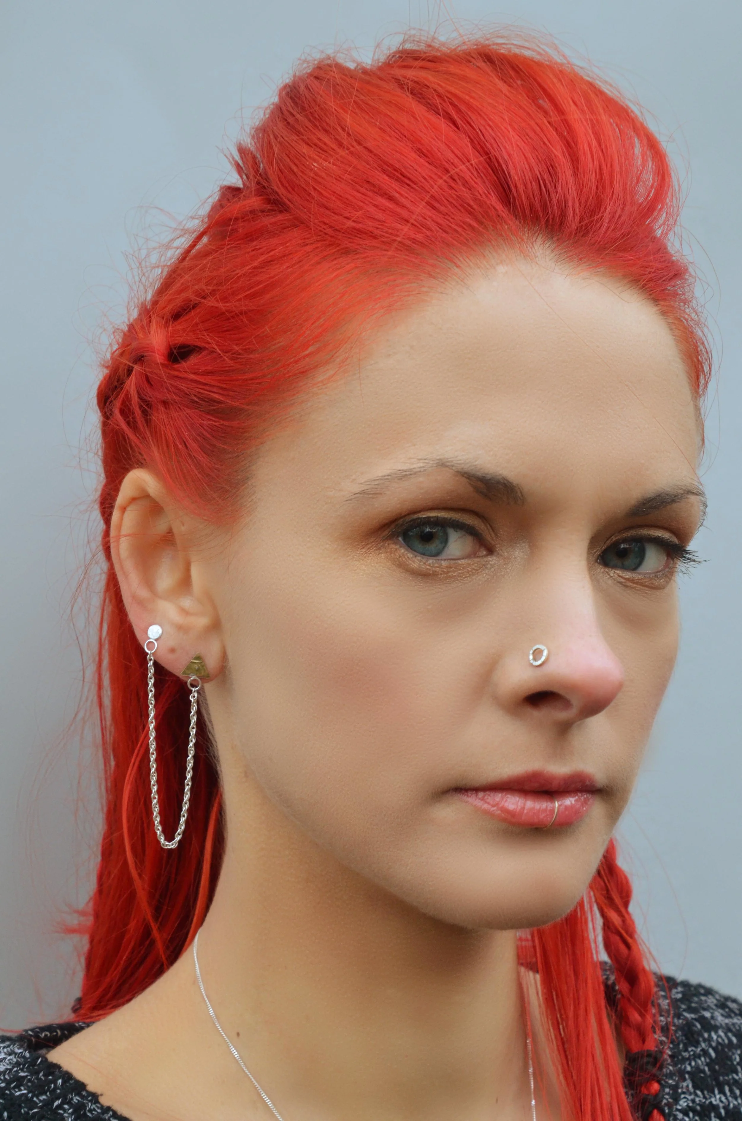 handmade silver earring and nose stud on model