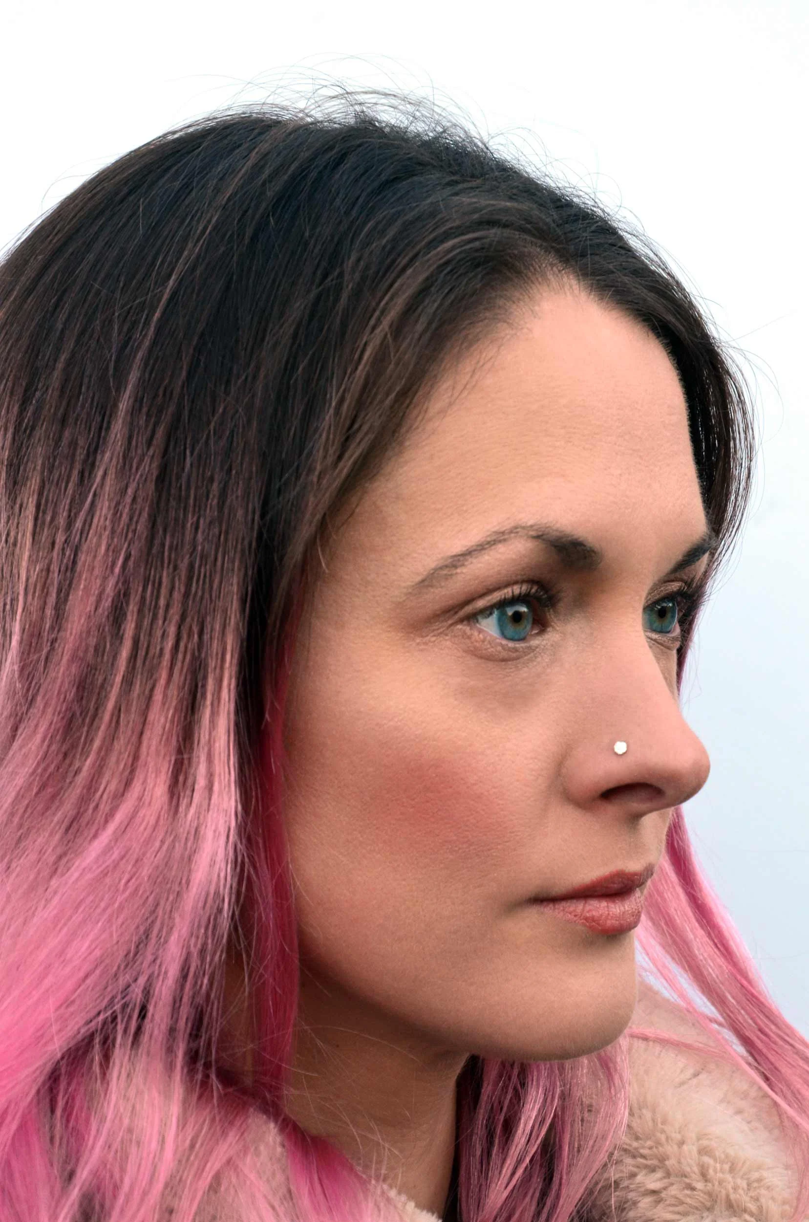 Tiny disc nose stud on model by victoria grace silversmith