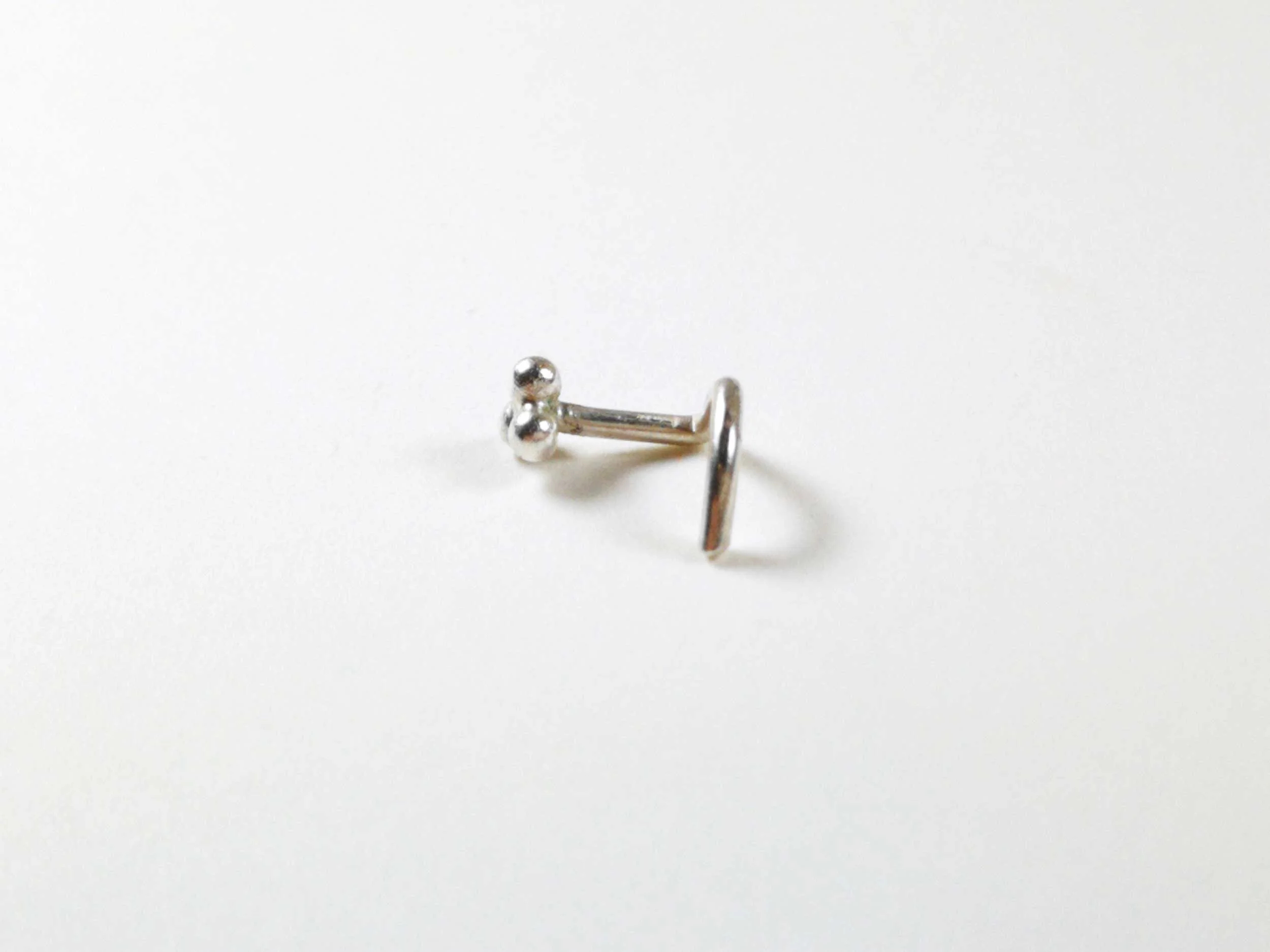 Handmade-tiny-silver-nose-stud-side-view-white-background.jpg