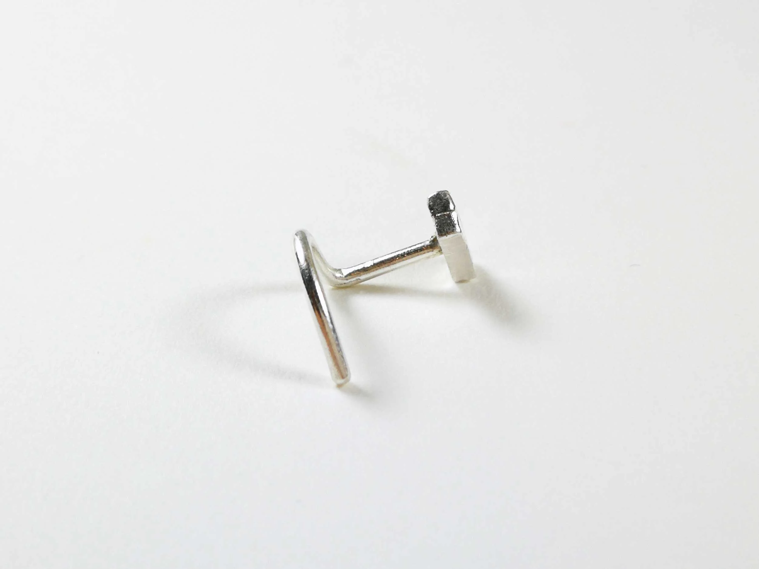 tiny-handmade-silver-nose-stud-on-white-background.jpg
