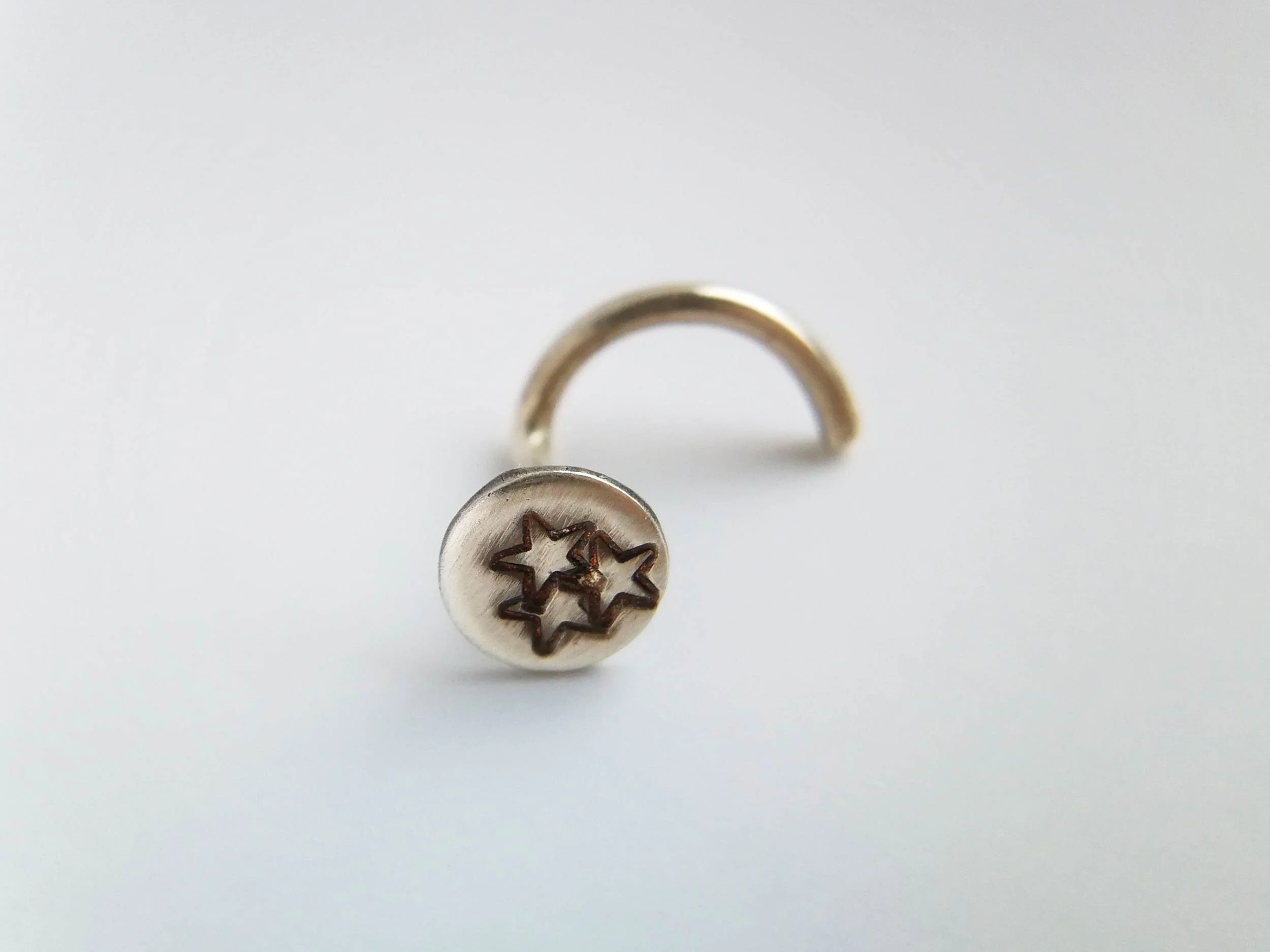 Star stamps oxidised nose stud product photo white background