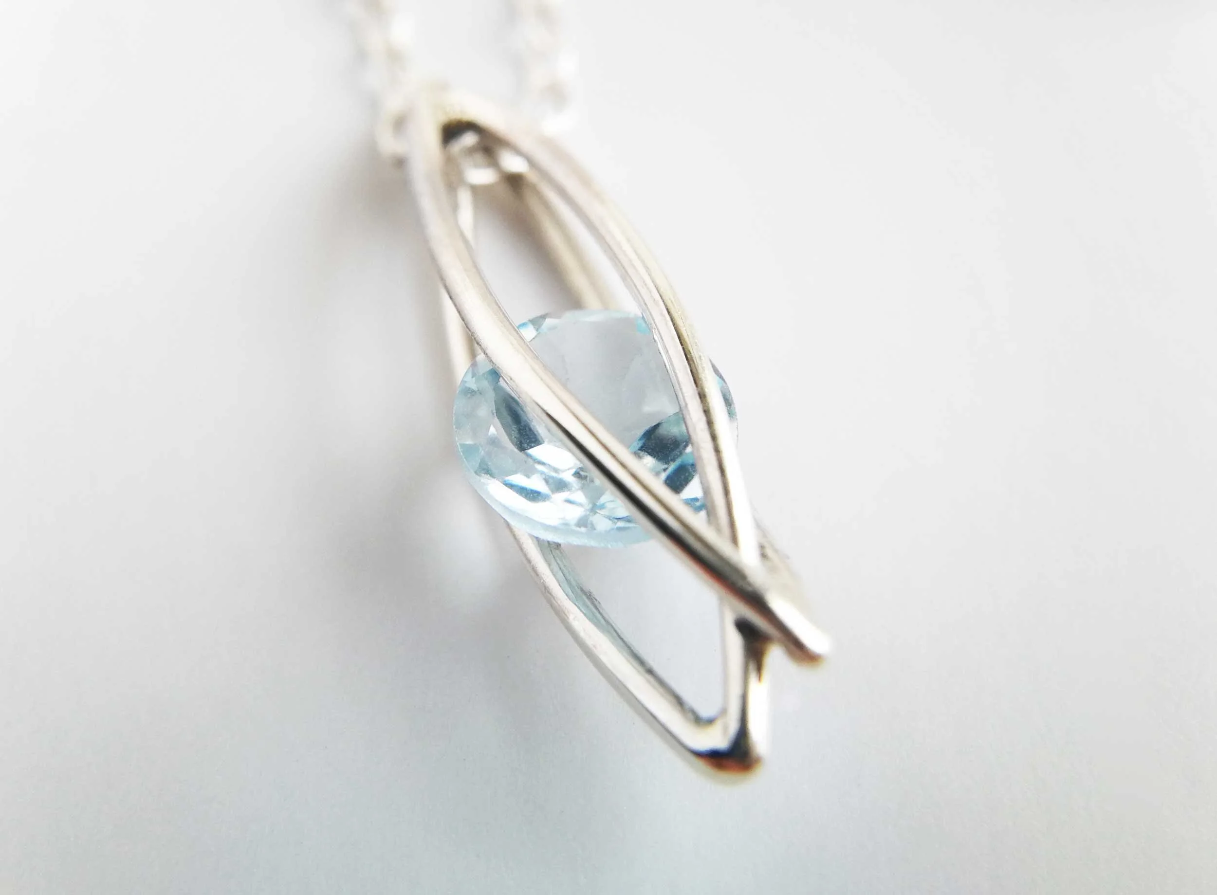 caged blue topaz necklace handmade in uk white background