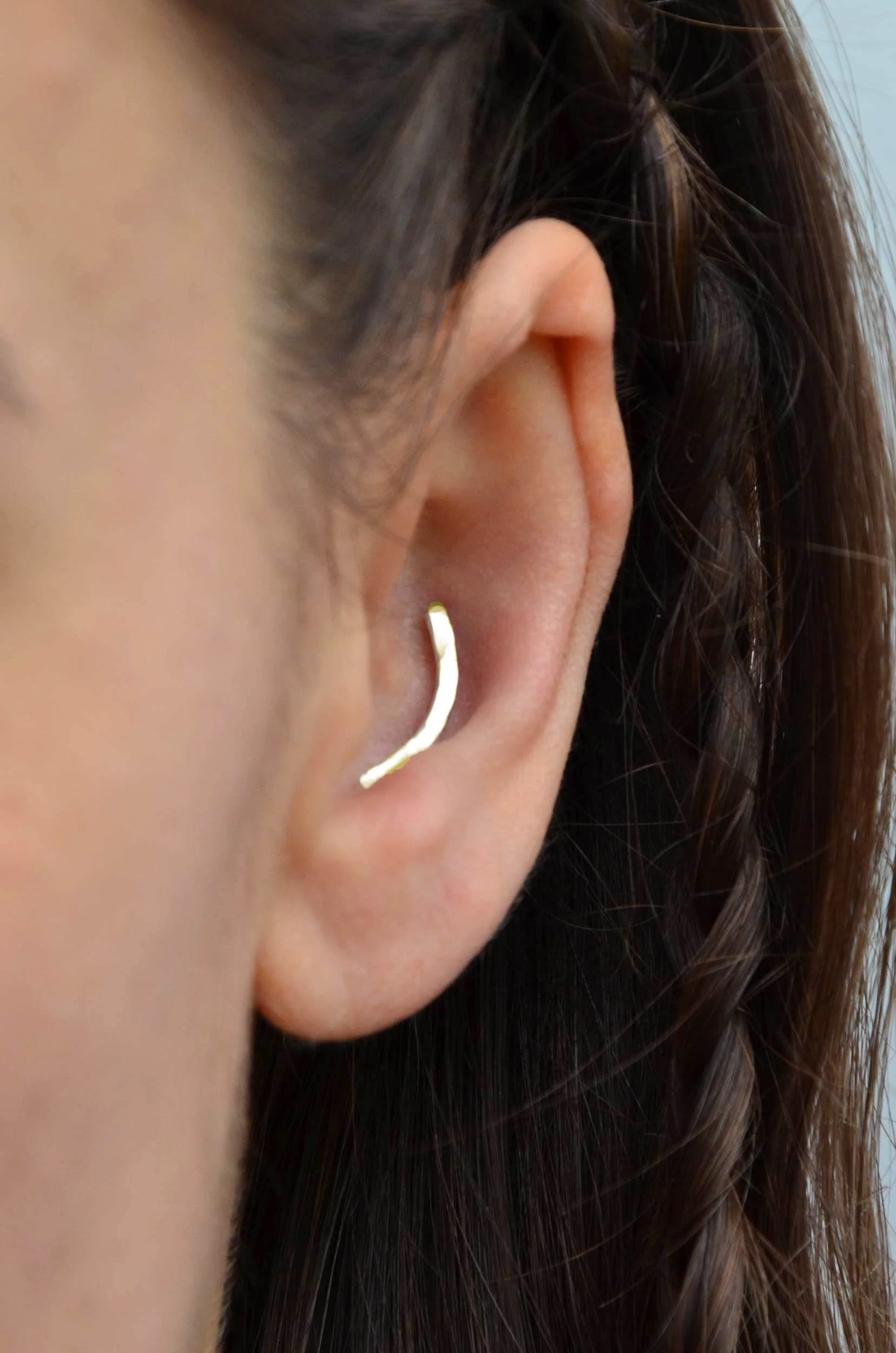 handmade solid gold conch earring on model