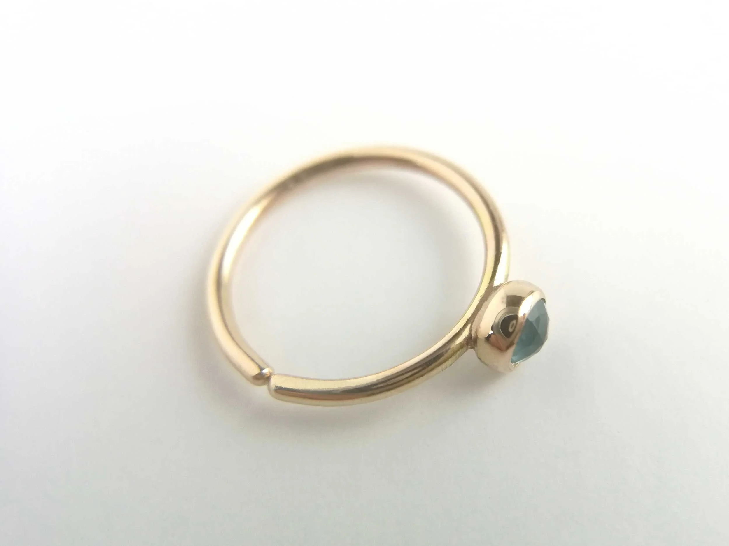 14ct gold conch hoop blue topaz on white background