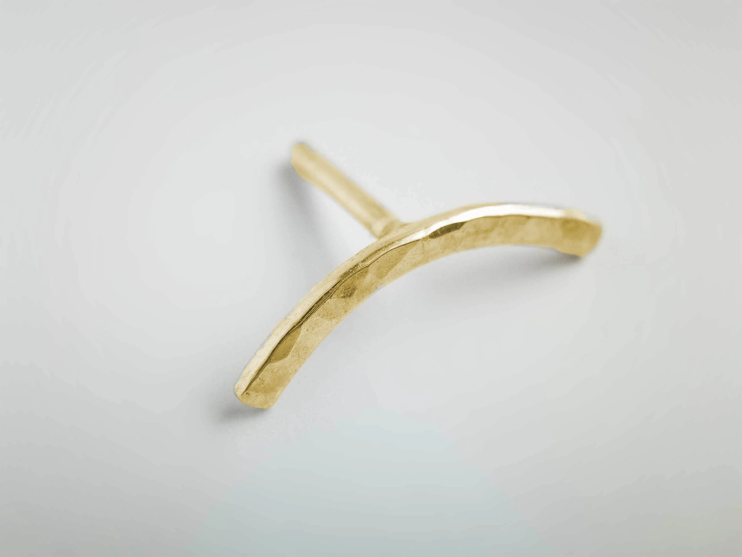 9k gold hammered conch earring on white background
